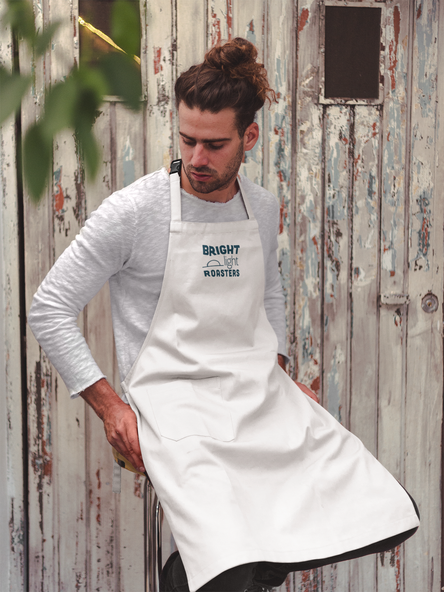 portrait-of-a-man-wearing-an-apron-mockup-sitting-on-a-stool-a19869.png