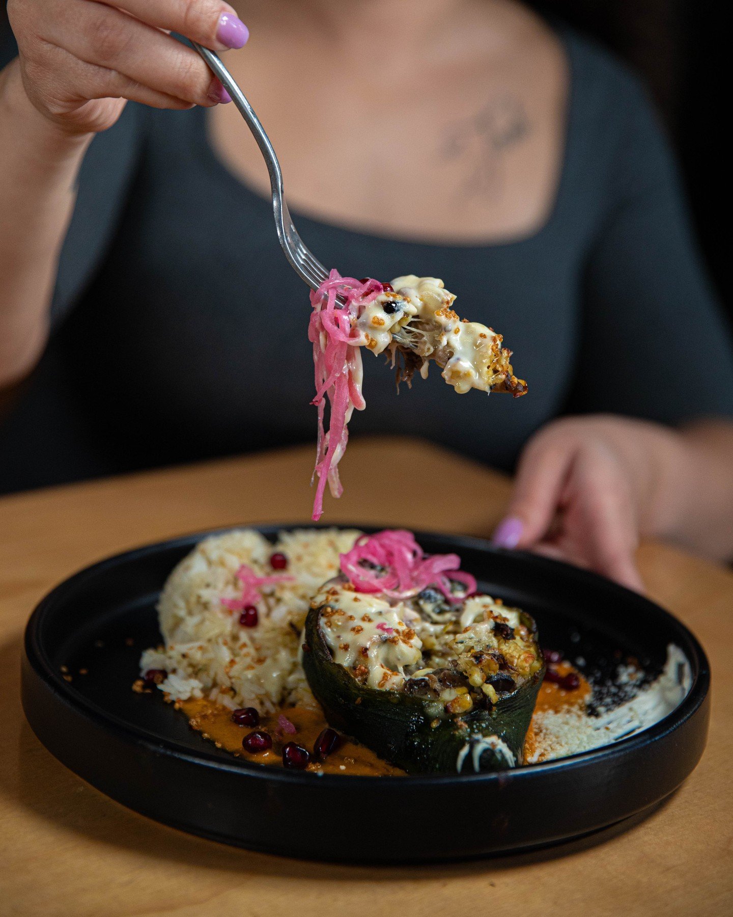 Our Relleno is a tantalizing dish that features poblano peppers stuffed with braised wild mushrooms, topped with a mouthwatering corn and arbol chile salsa, gruy&egrave;re cheese fondue, onions, and a burst of pomegranate. 🌶️