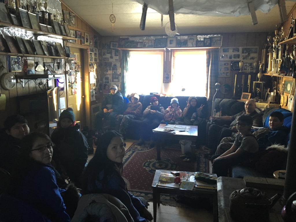 Huslia Junior HS students listening to Musher Wilson Sam telling stories.