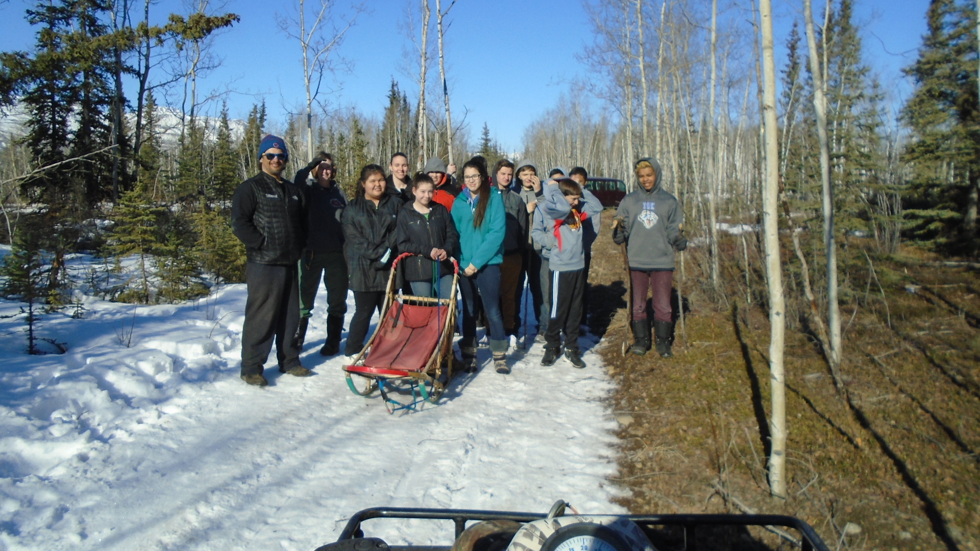 Tok School students ready to ride sled with Hugh Neff's dogs.