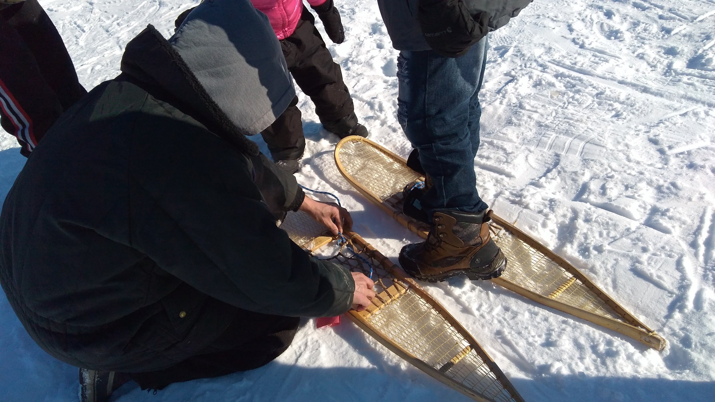 Merreline A. Kangas School (Ruby) student puts on snowshoes.