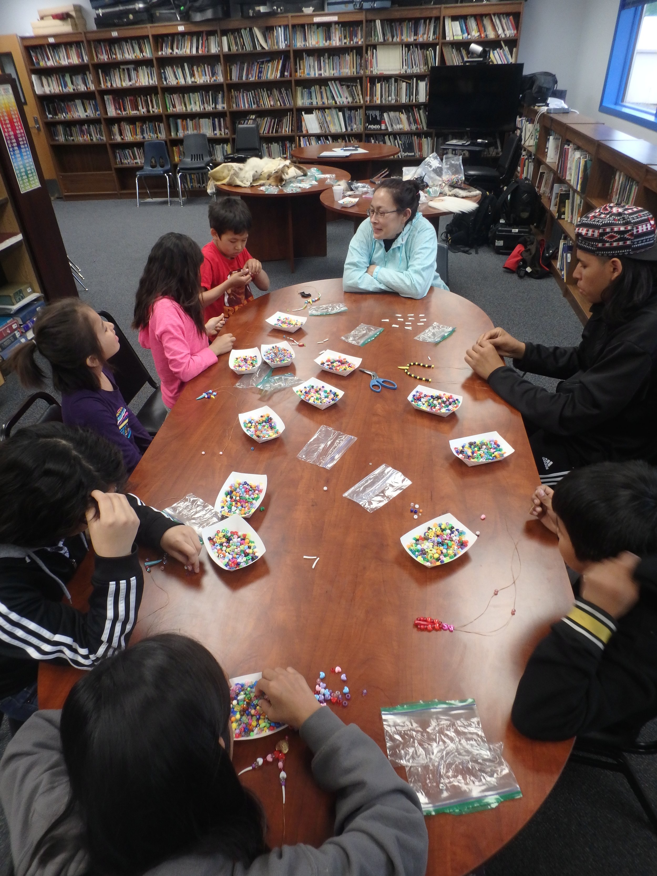 Minto School students learn to bead from Quest guest speaker.