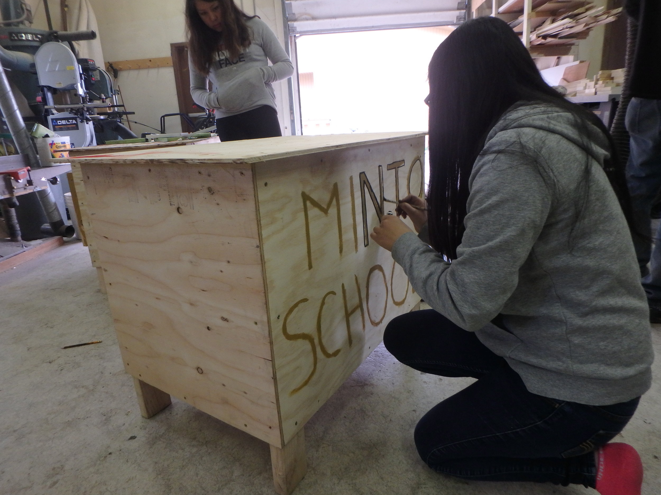 Minto School students finish building a dog box.