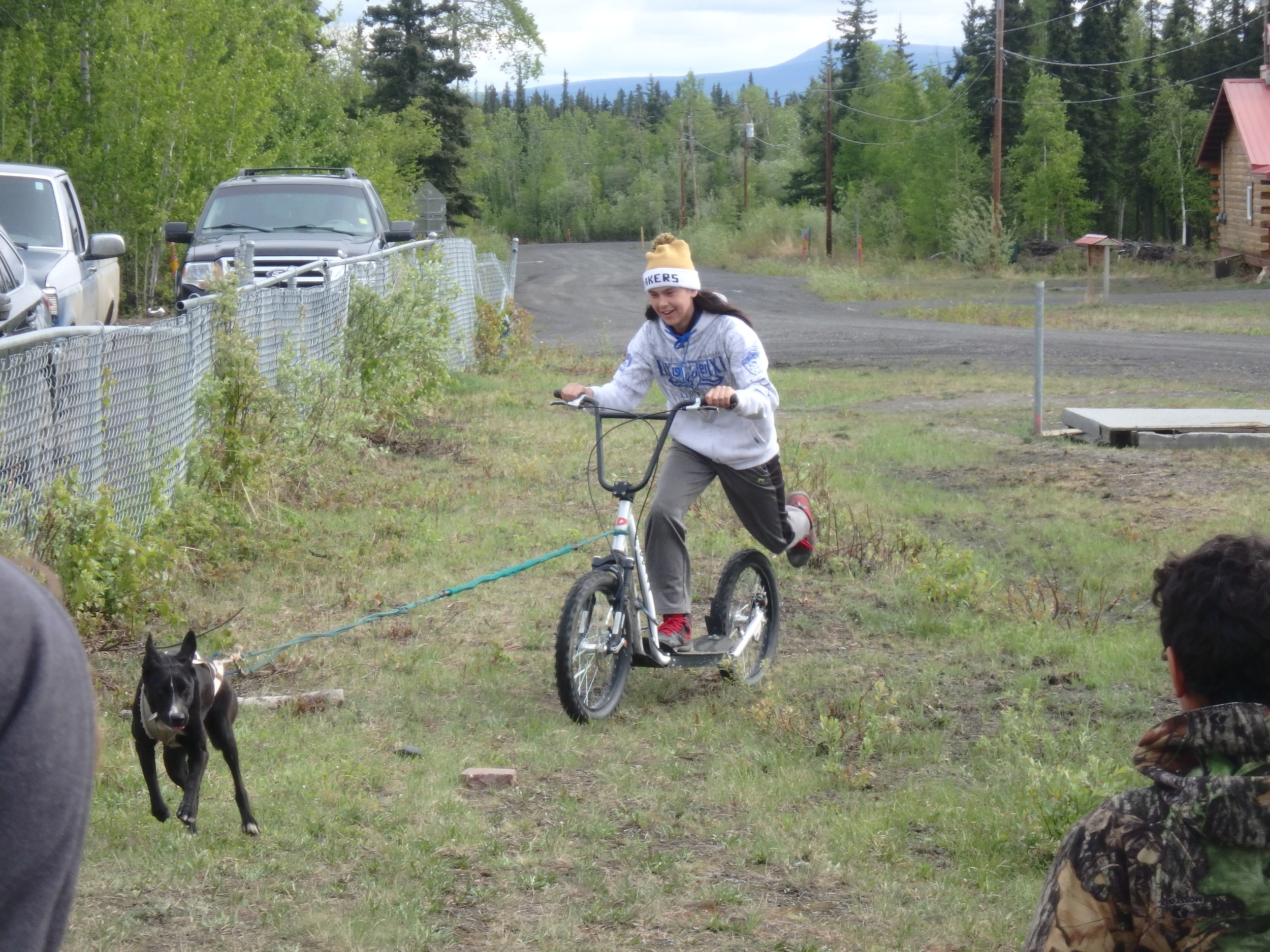 Minto School student learns how to bike with a dog.