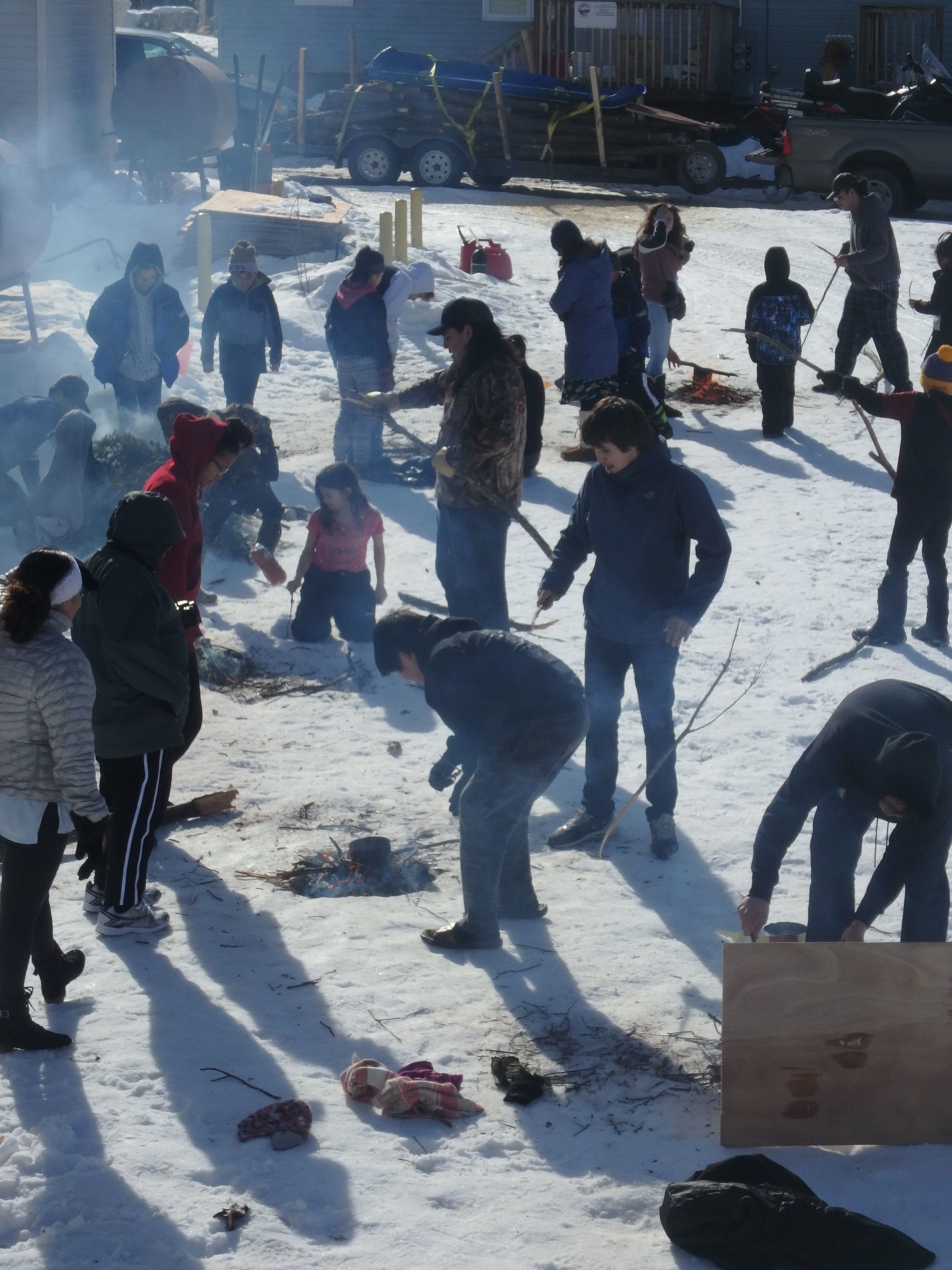 Minto Spring Carnival students learn to brew tea in snow pit.