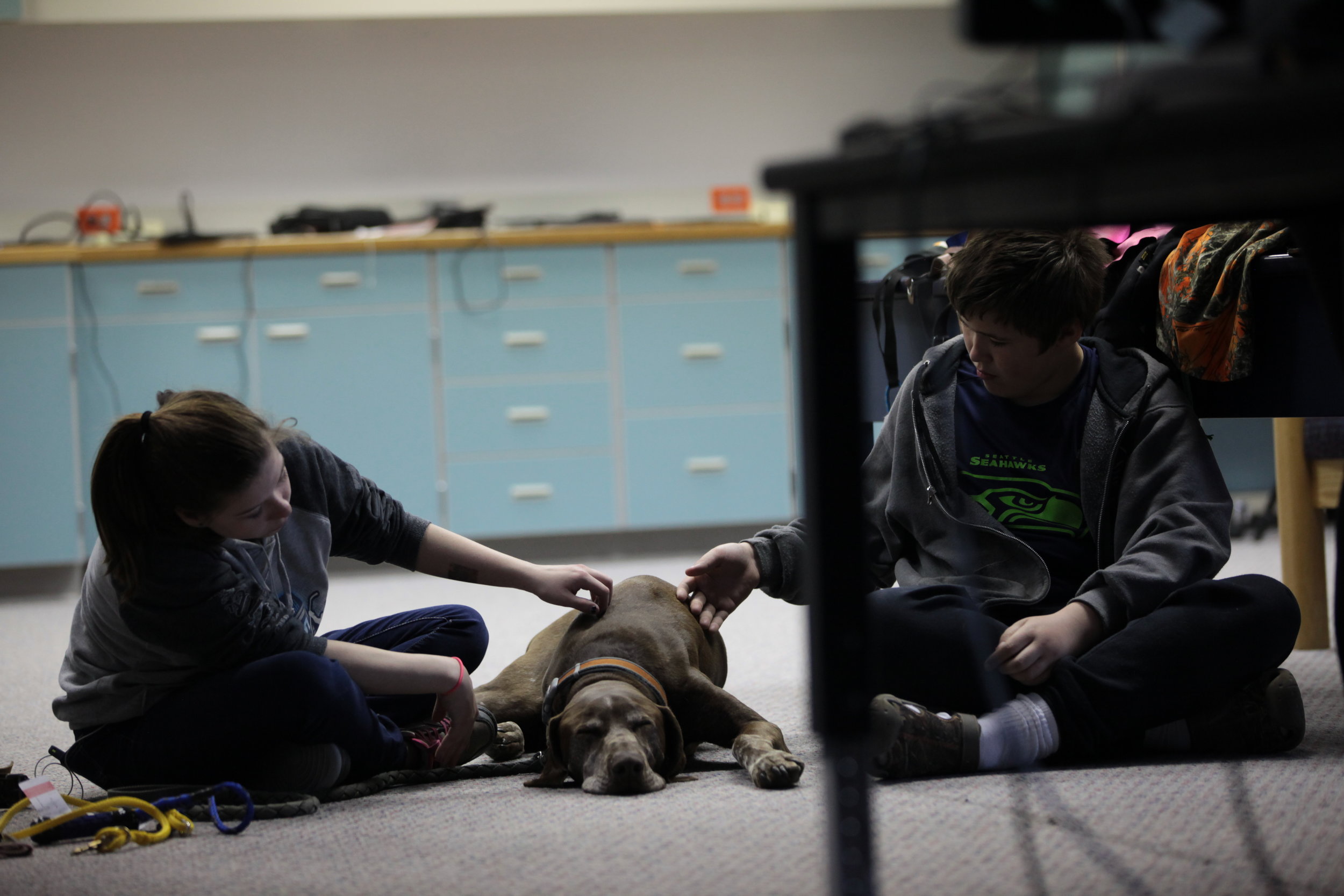 Tok students with dog in classroom.