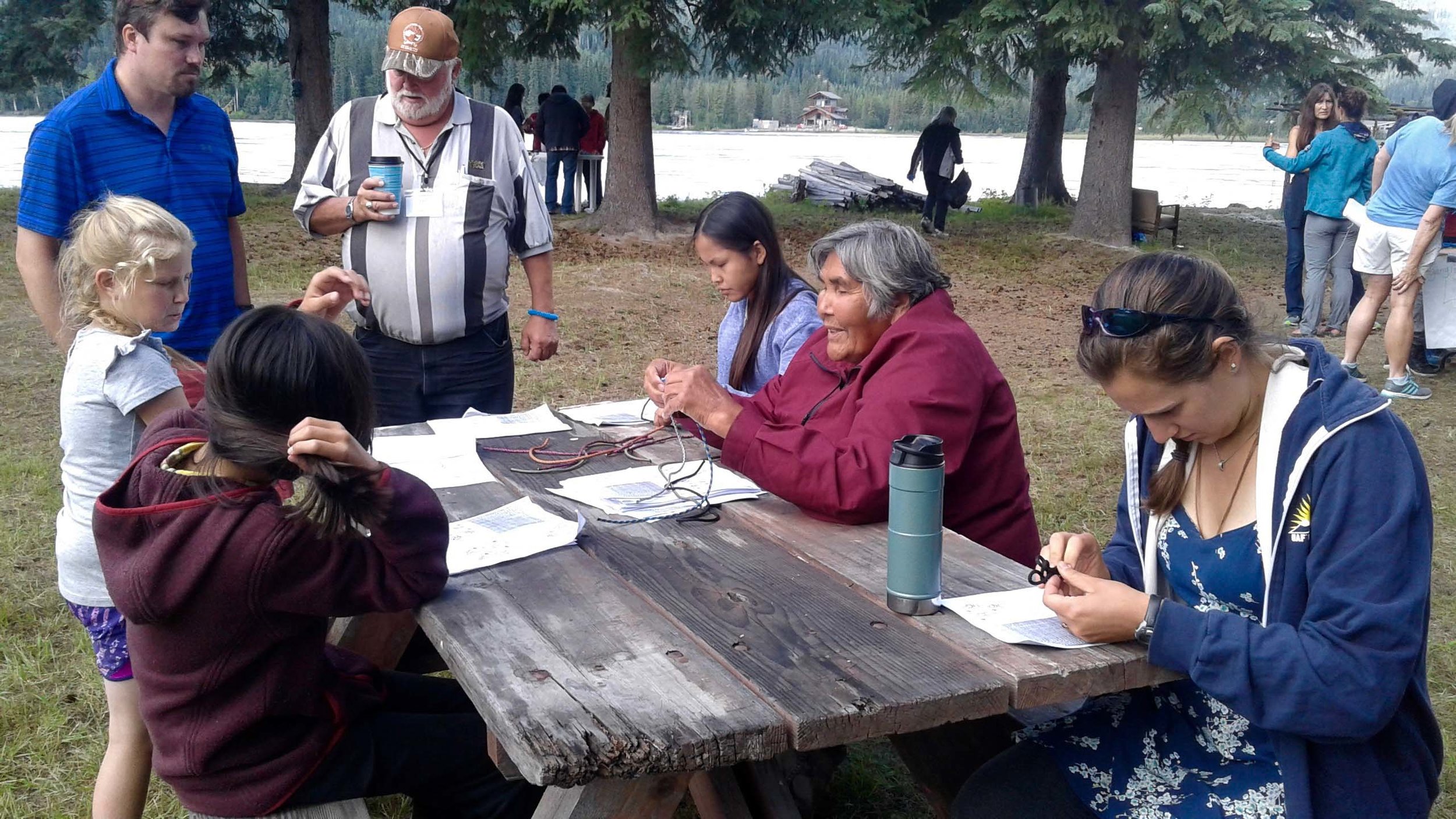 Dog musher teachers shows students and teachers how to tie knots.