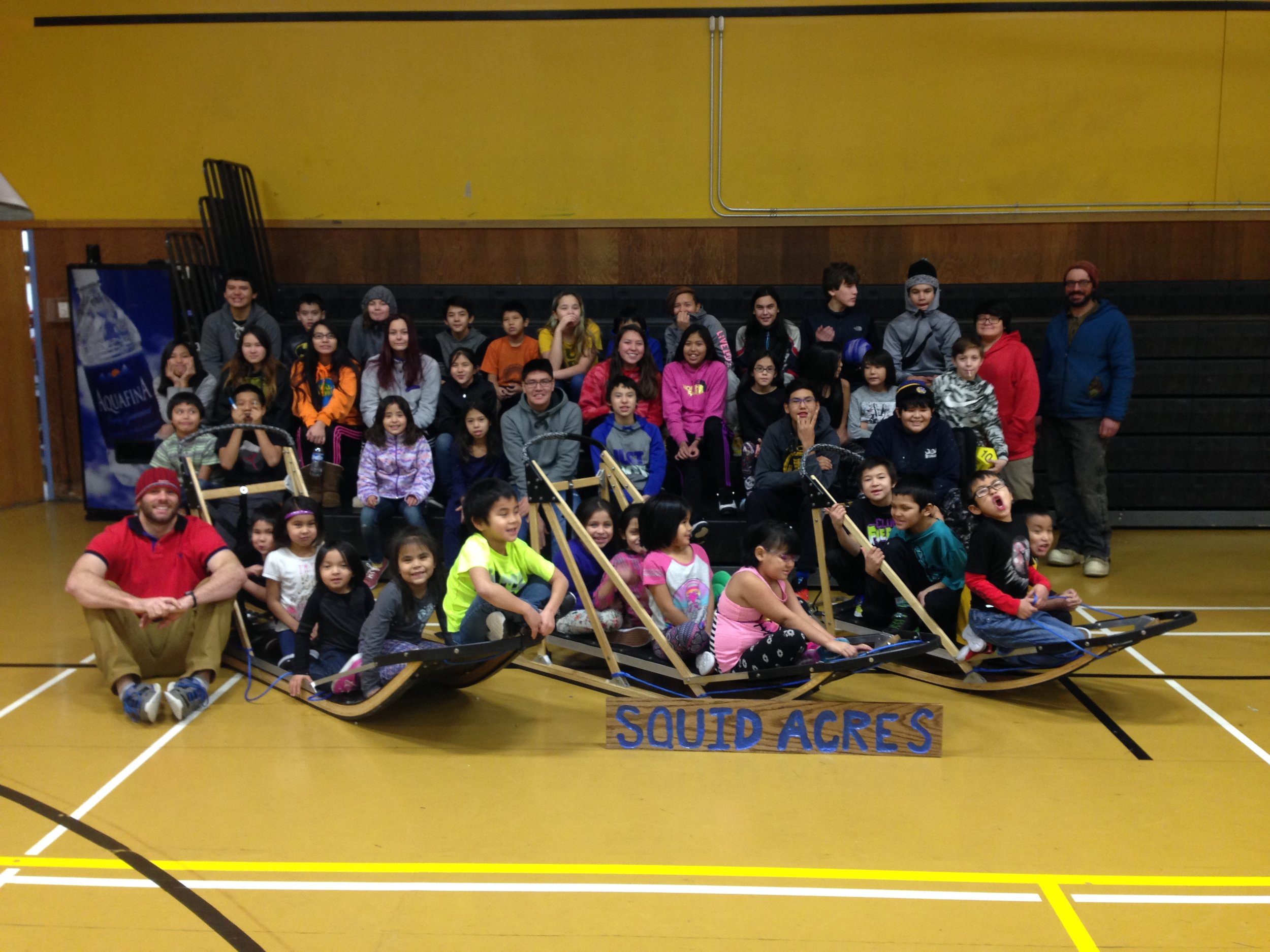 Students posing with the three sleds they built.