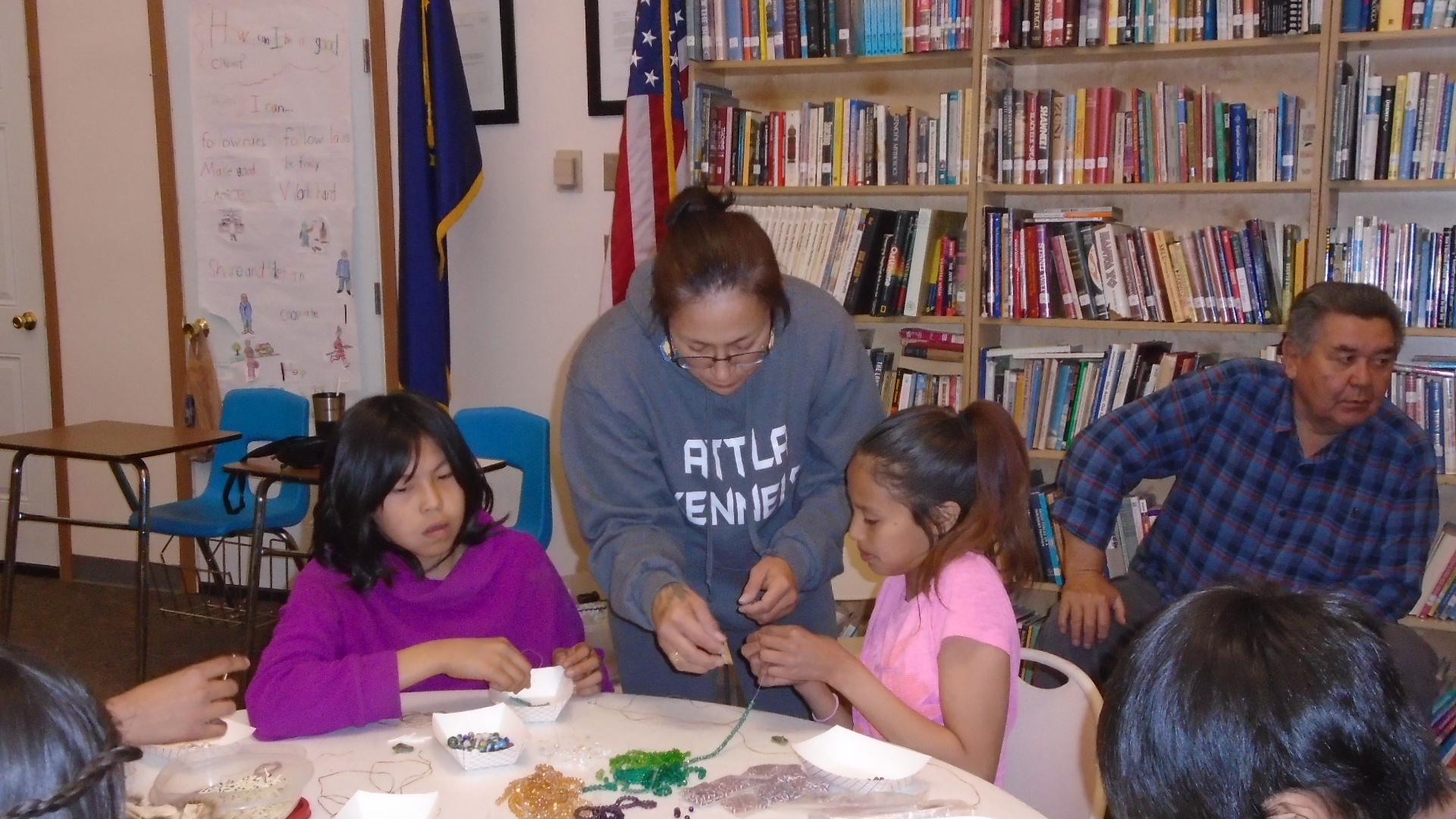 Students learn to bead with Amanda Attla.