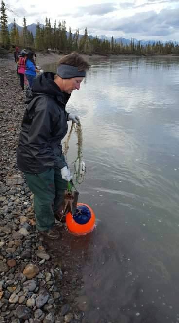 Roni Noonan-Agre teaching students how to string out a net.