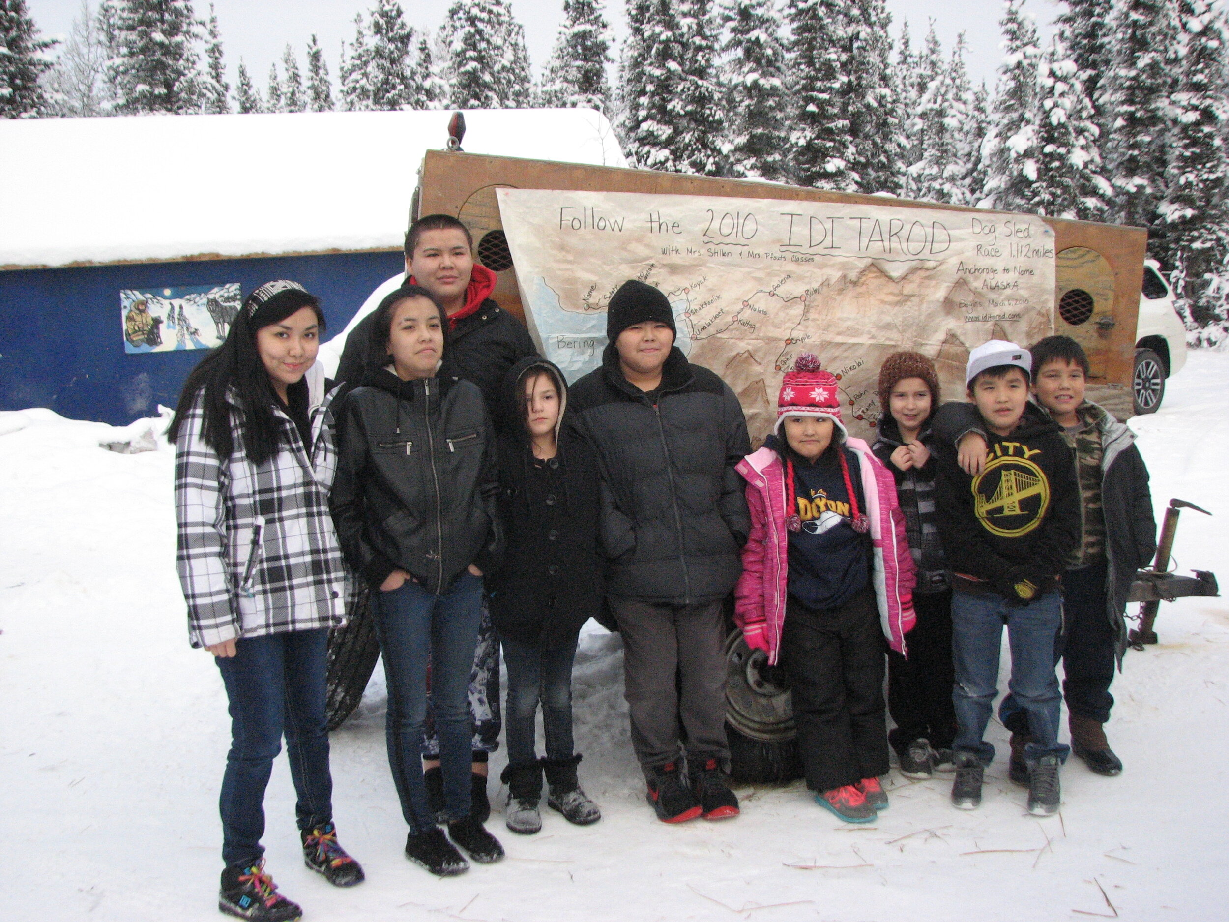 5.e- Tanacross School students  and Leonard Sanford by Iditarod map at Hugh Neff kennel by Roni Noonan-Agre.JPG