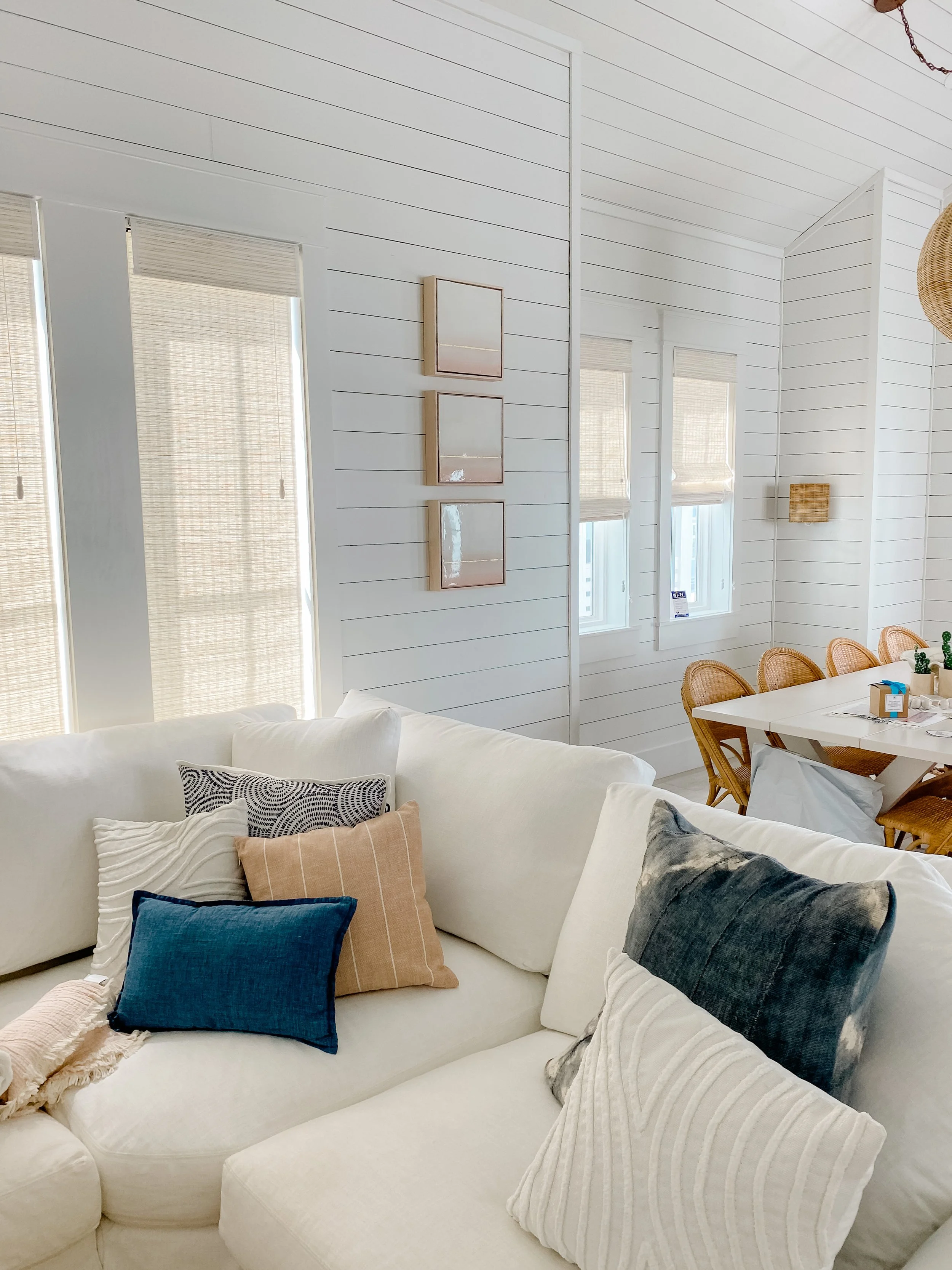 Small framed artwork wall decor hangs in a coastal beach house.