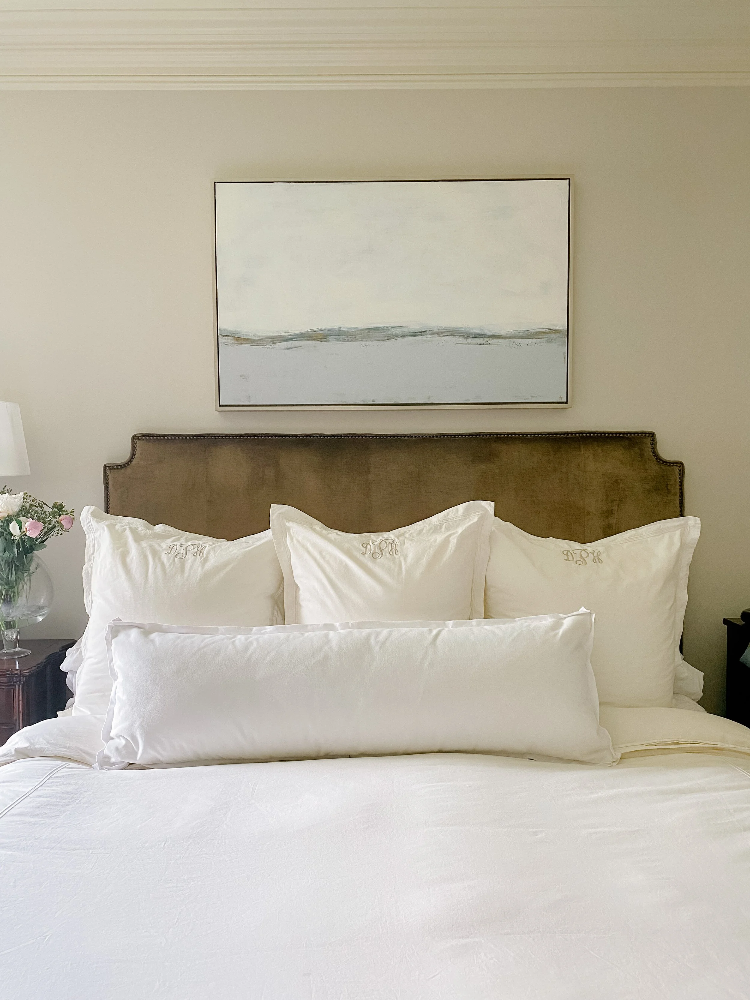 Nautical wall decor in blue and white hangs over a bed.