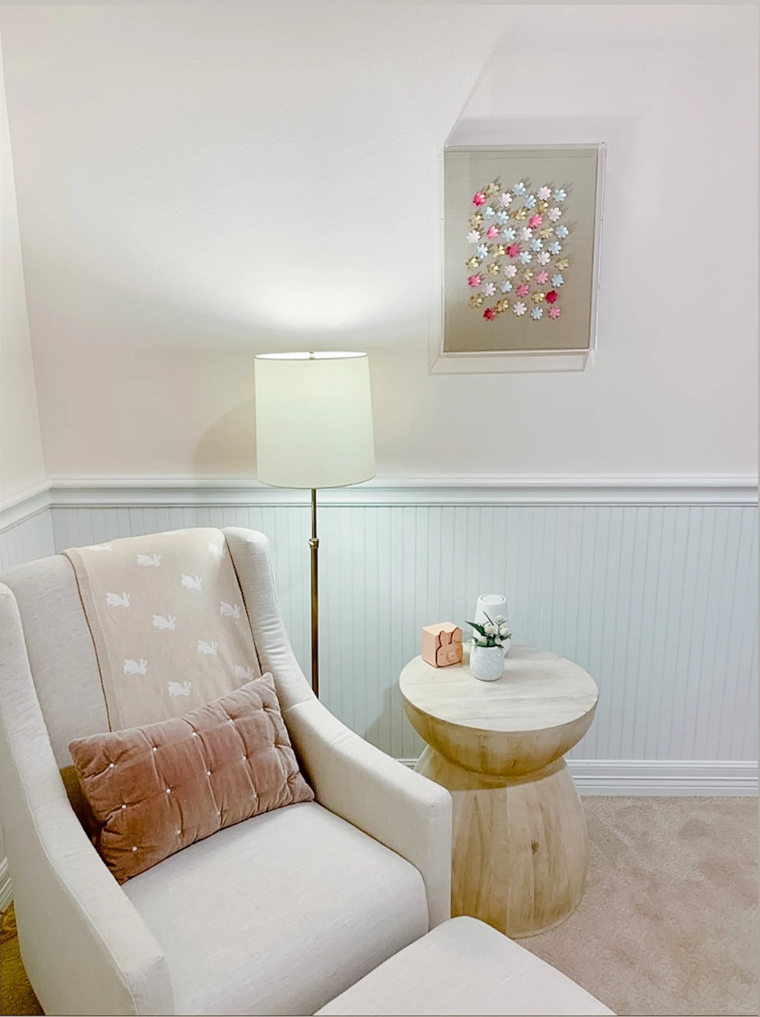 3D flowers painted in pinks and blues framed in an acrylic shadowbox