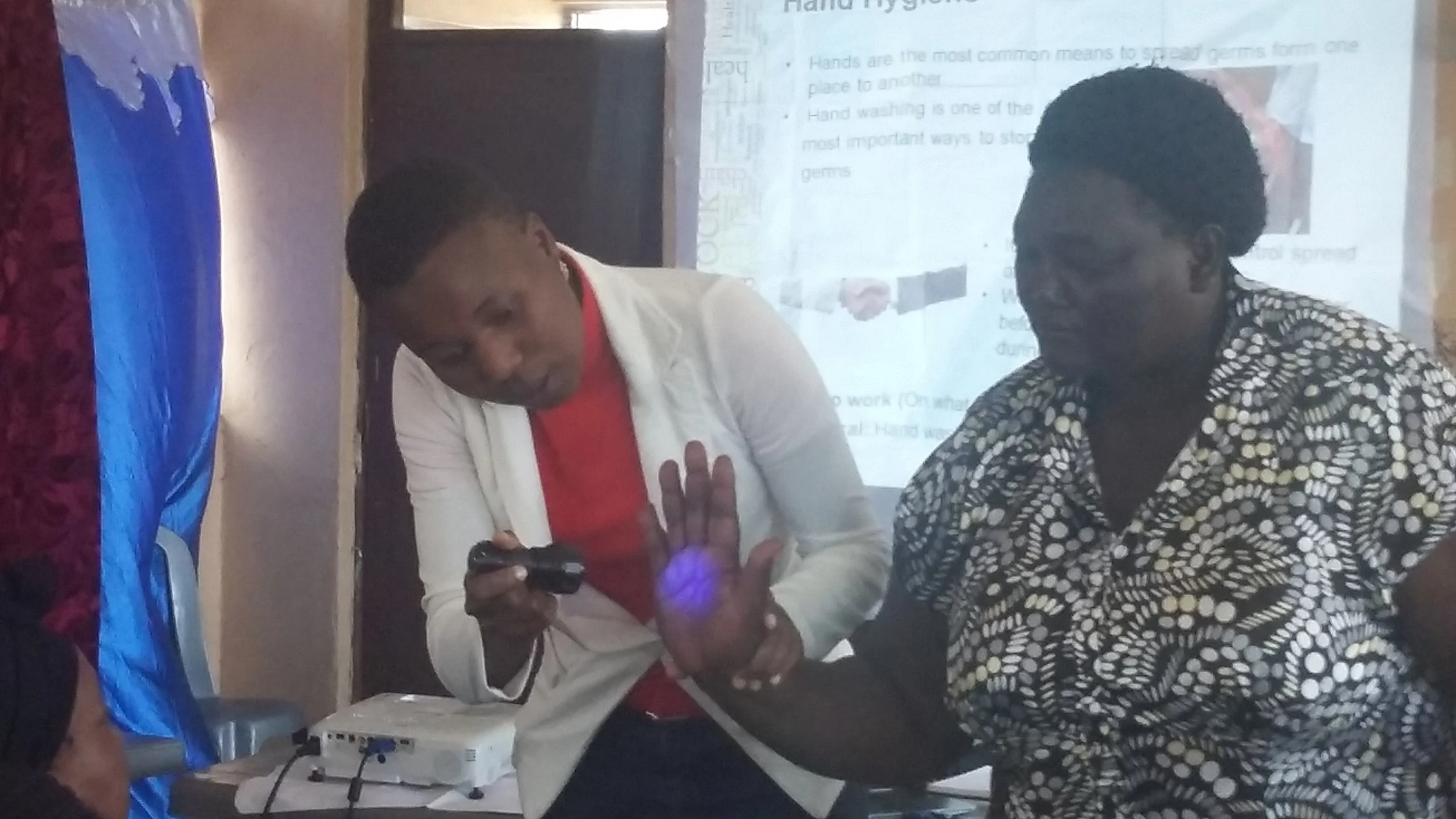 Lorraine of ILRI takes participants through hand washing procedure