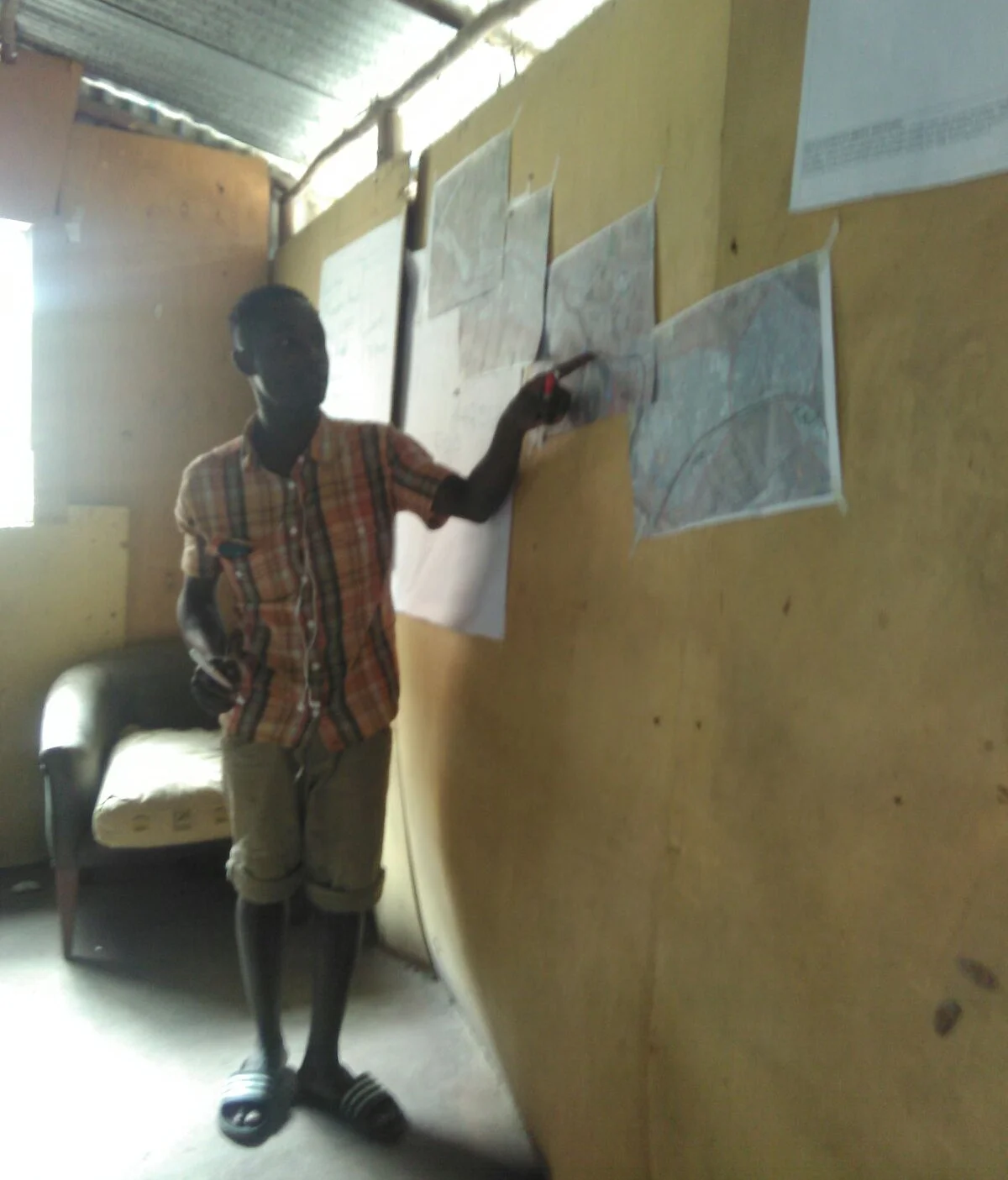 A youth from Mukuru Kayaba in Nairobi identifies some of the settlement boundaries.