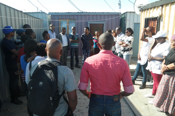 Group gathers in a courtyard in Sheffield Road