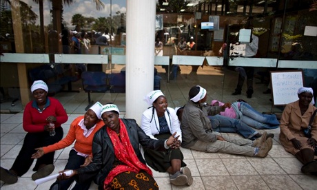 Mukuru slum women barricade the entrance to the health ministry. The writing on their headbands reads ‘togetherness’ in Swahili.Photograph: Karel Prinsloo/Guardian