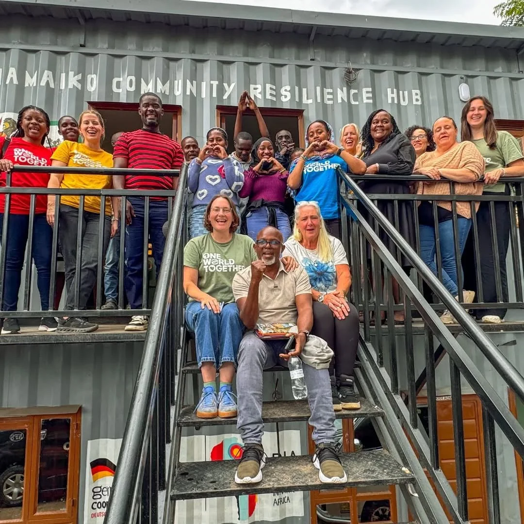 Day 2 of the One World Together Summit moved beyond dialogue into lived community action as delegates from the University of Manchester, Community Savers, Seed of Hope, and Play it Forward visited the Muungano wa Wanavijiji Kiamaiko Resilience Hub in