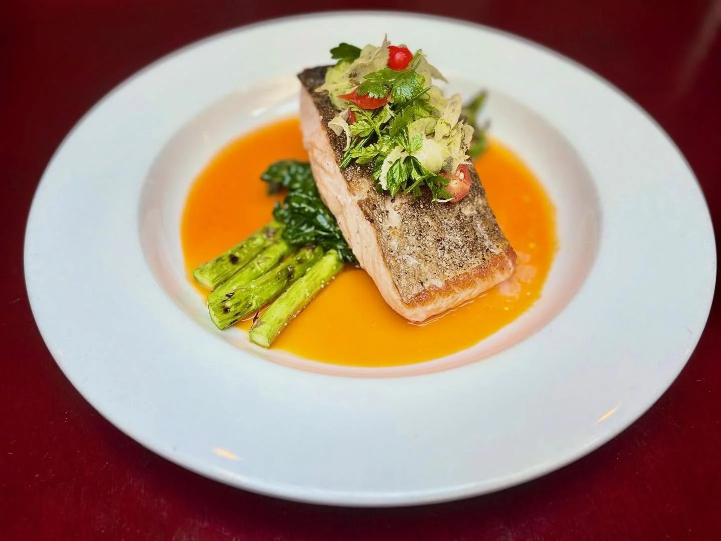 They say you eat with your eyes first, and how could you not with this vibrant salmon dish? Served with Tuscan kale, grilled asparagus, Peruvian sweet pepper and carrot butter, then topped with a shaved fennel slaw and crispy capers for the perfect f
