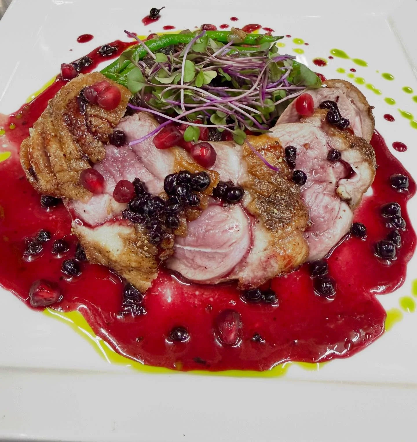 Maple Leaf Duck Breast- perfectly seared duck breast paired with earthy green lentils and crispy Haricot Vert Beans. Sweet dried figs and vibrant pomegranate seeds add burst of flavor, all brought together with a rich huckleberry gastrique that balan