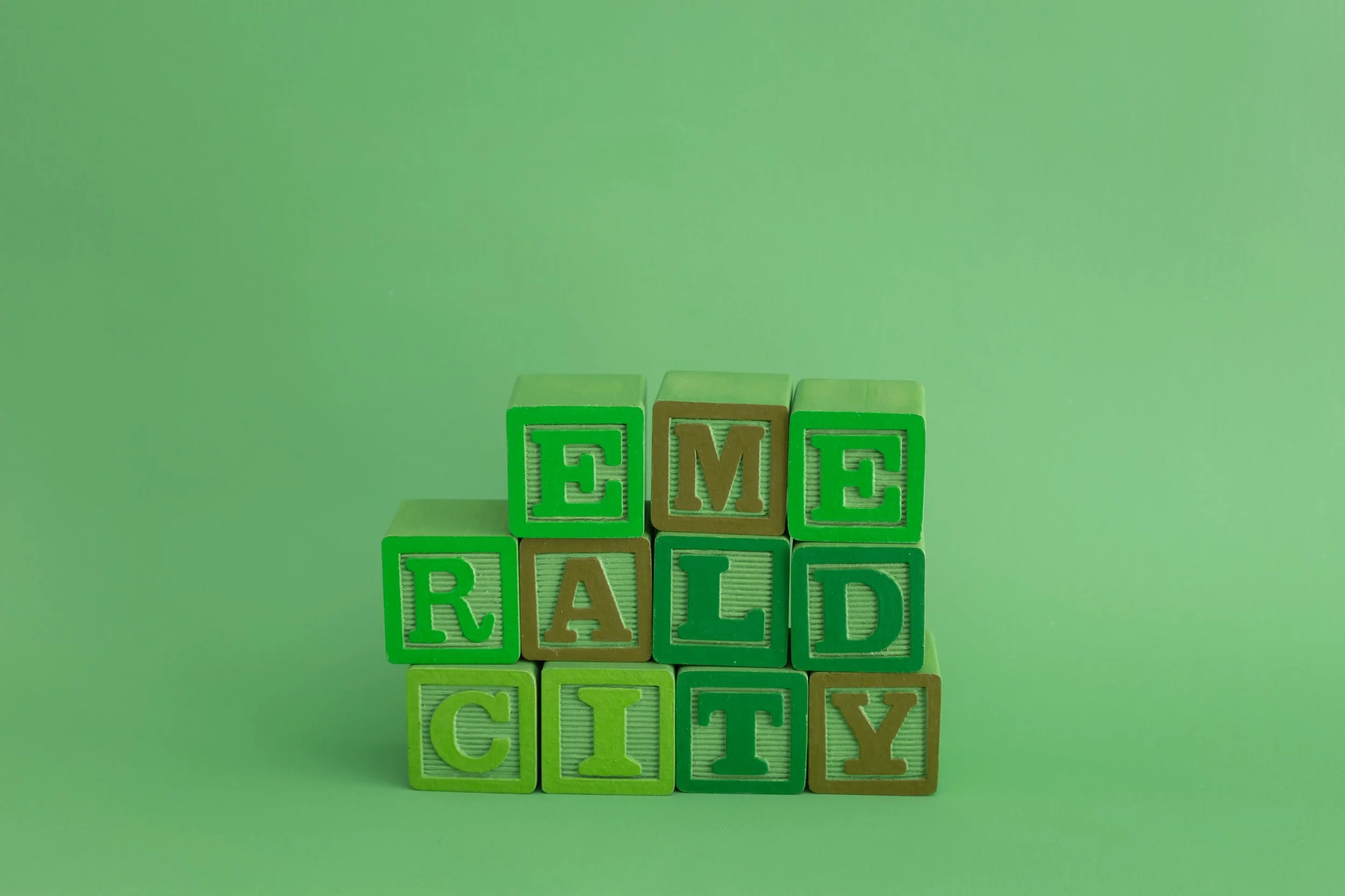 painted alphabet blocks spelling the words “Emerald City”
