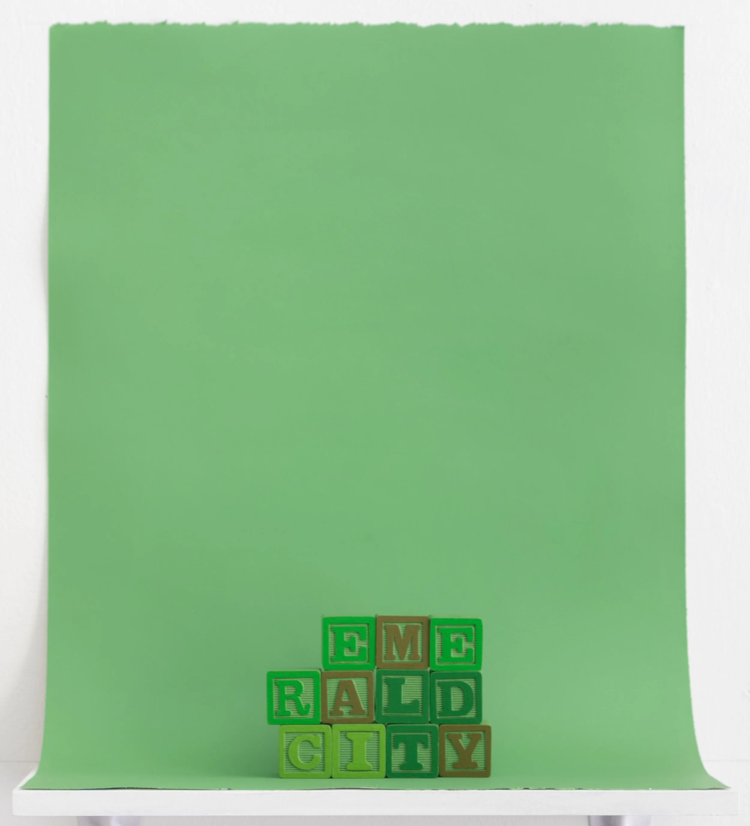 painted alphabet blocks spelling the words “Emerald City”