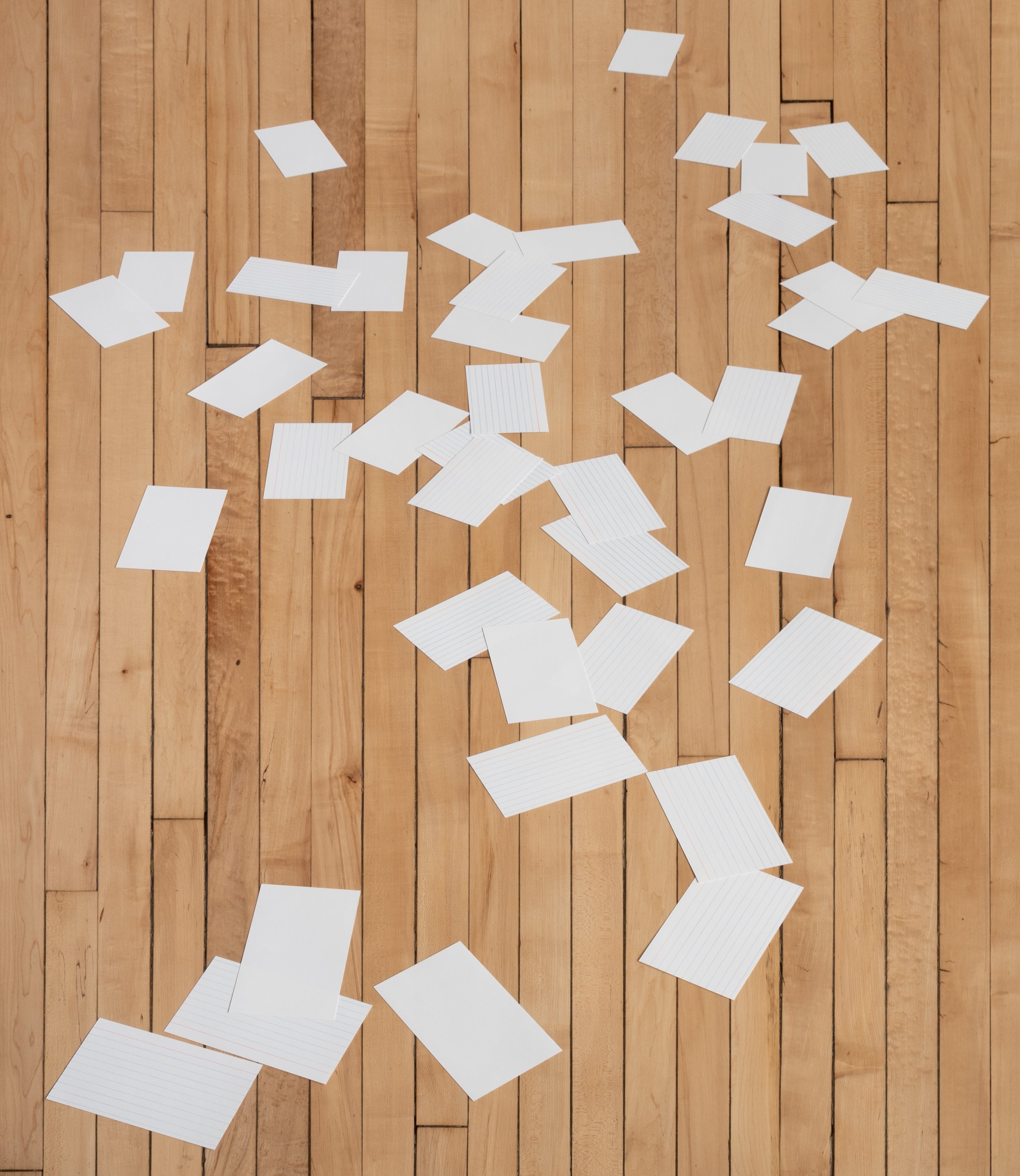 Set of forty index cards hand-cut and arranged on the floor to appear in perspective.