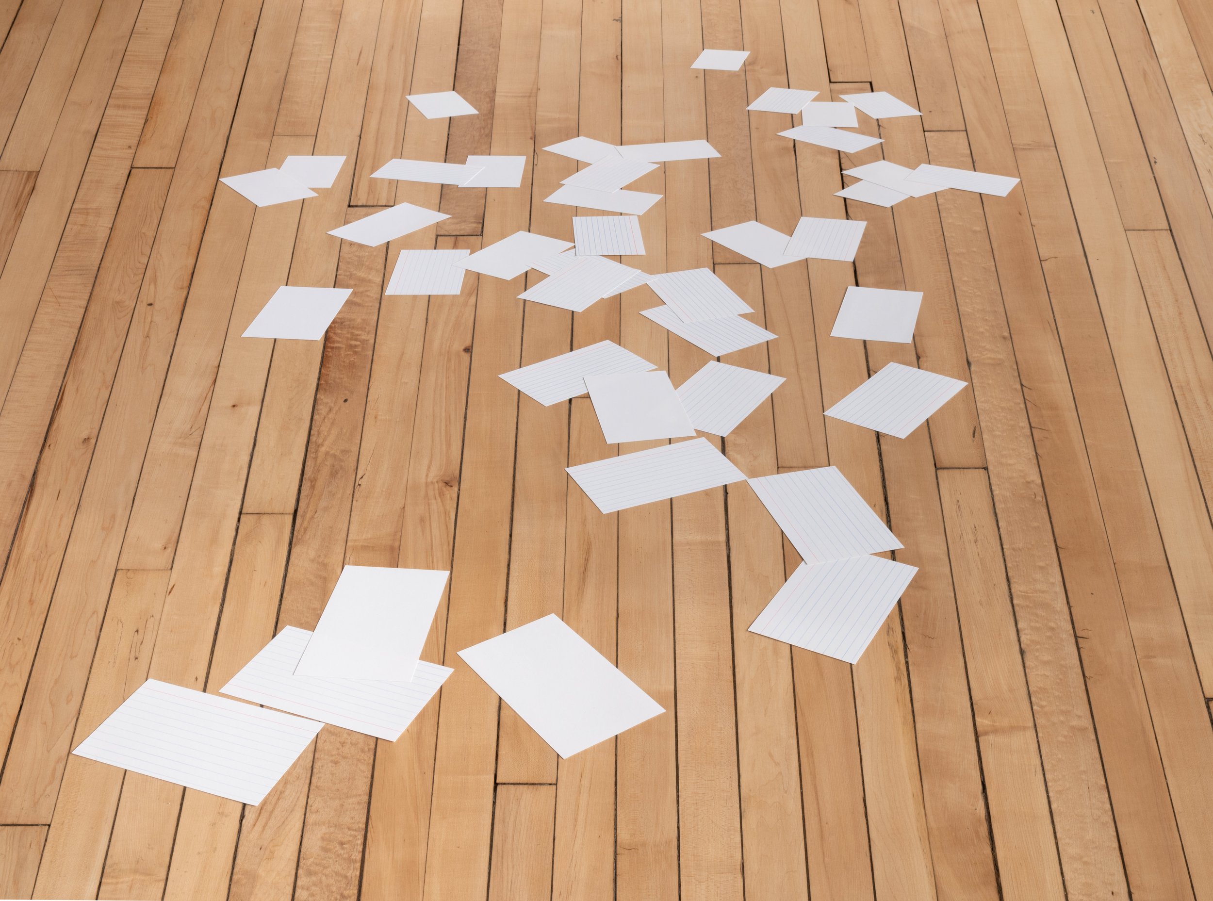 Set of forty index cards hand-cut and arranged on the floor to appear in perspective.