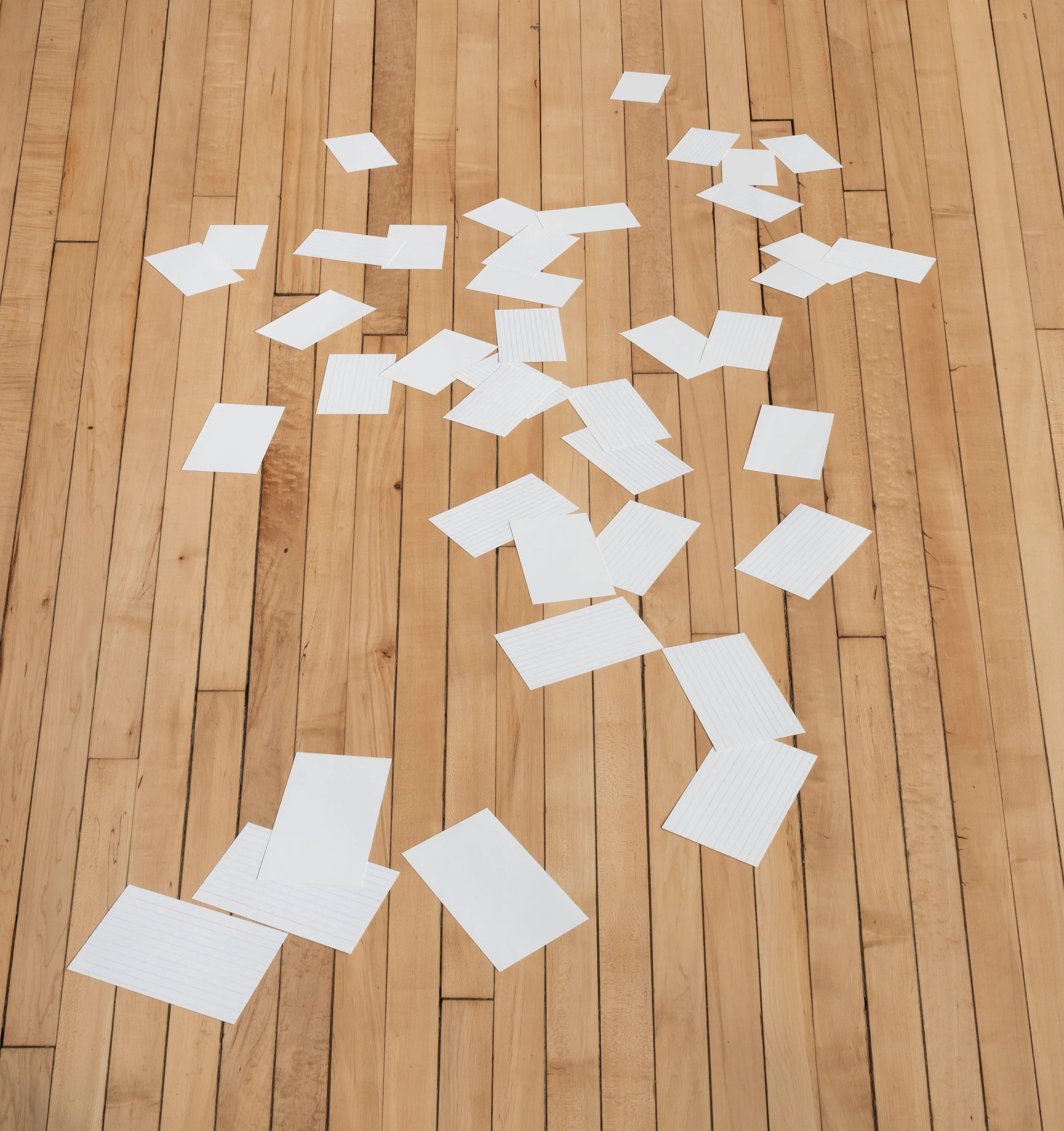 Set of forty index cards hand-cut and arranged on the floor to appear in perspective.