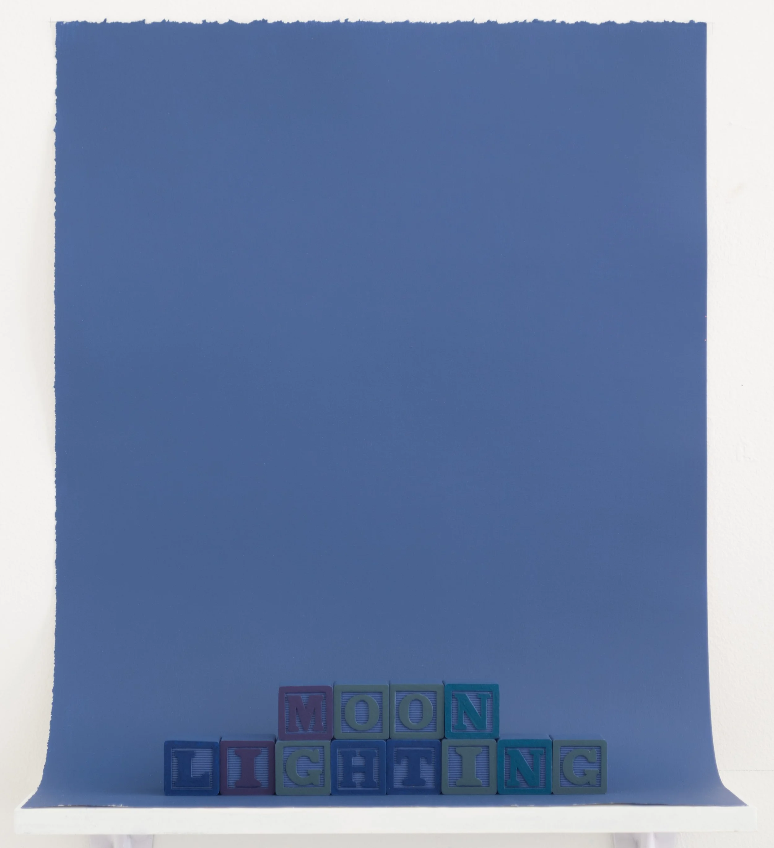 painted alphabet blocks spelling the word “Moonlighting”