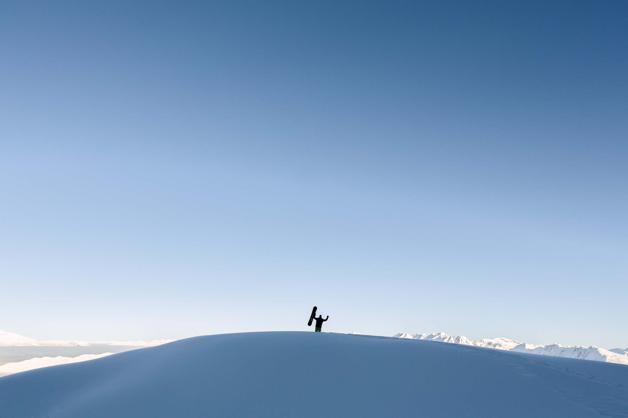 Snowboarder-mountain-top-silhouette