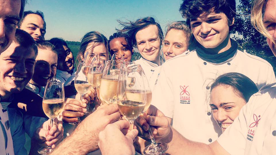 Jackie's students celebrating one of the many culinary milestones that they will reach throughout the course.
