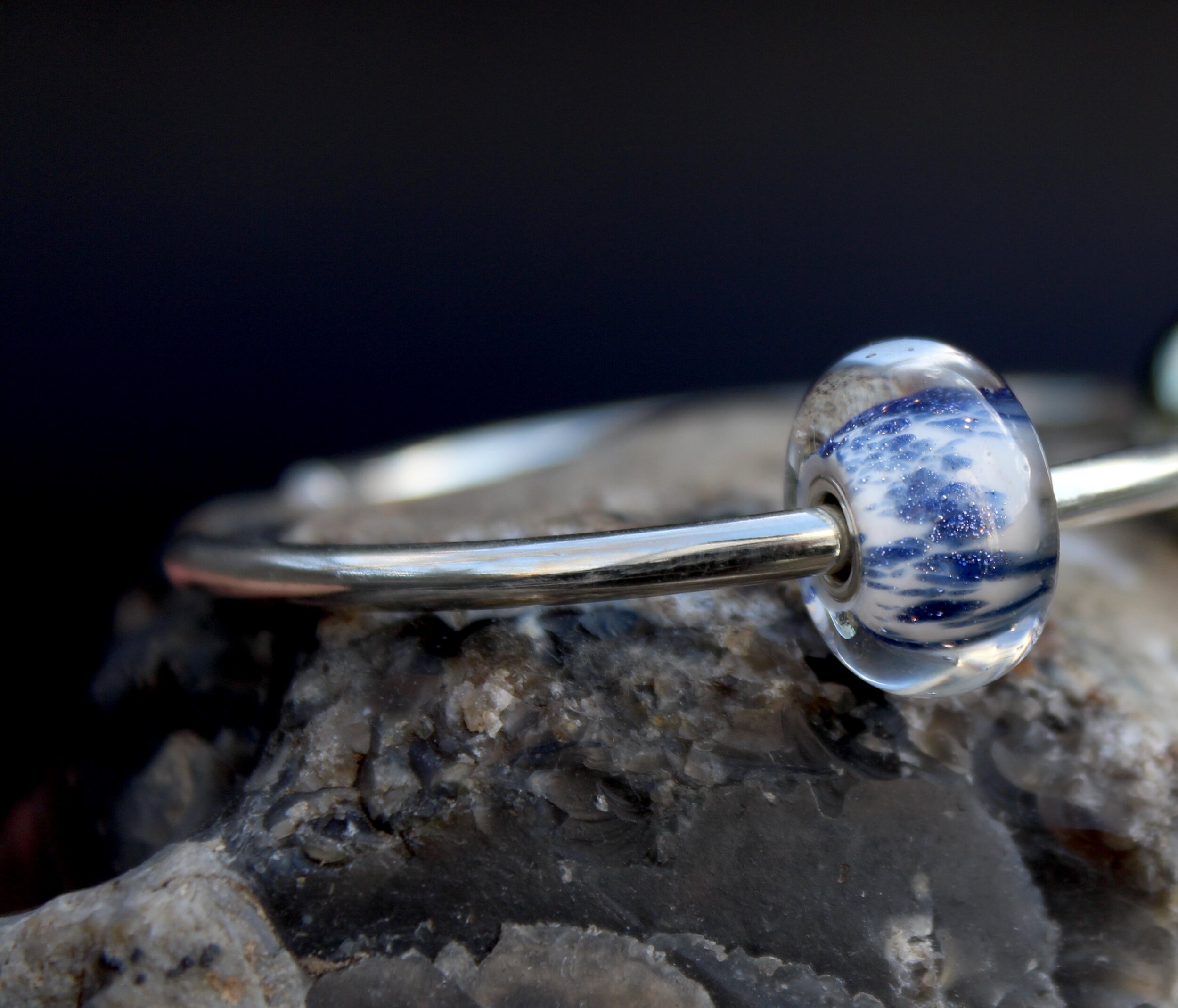 Handmade sterling silver bangle with blue sparkle charm bead