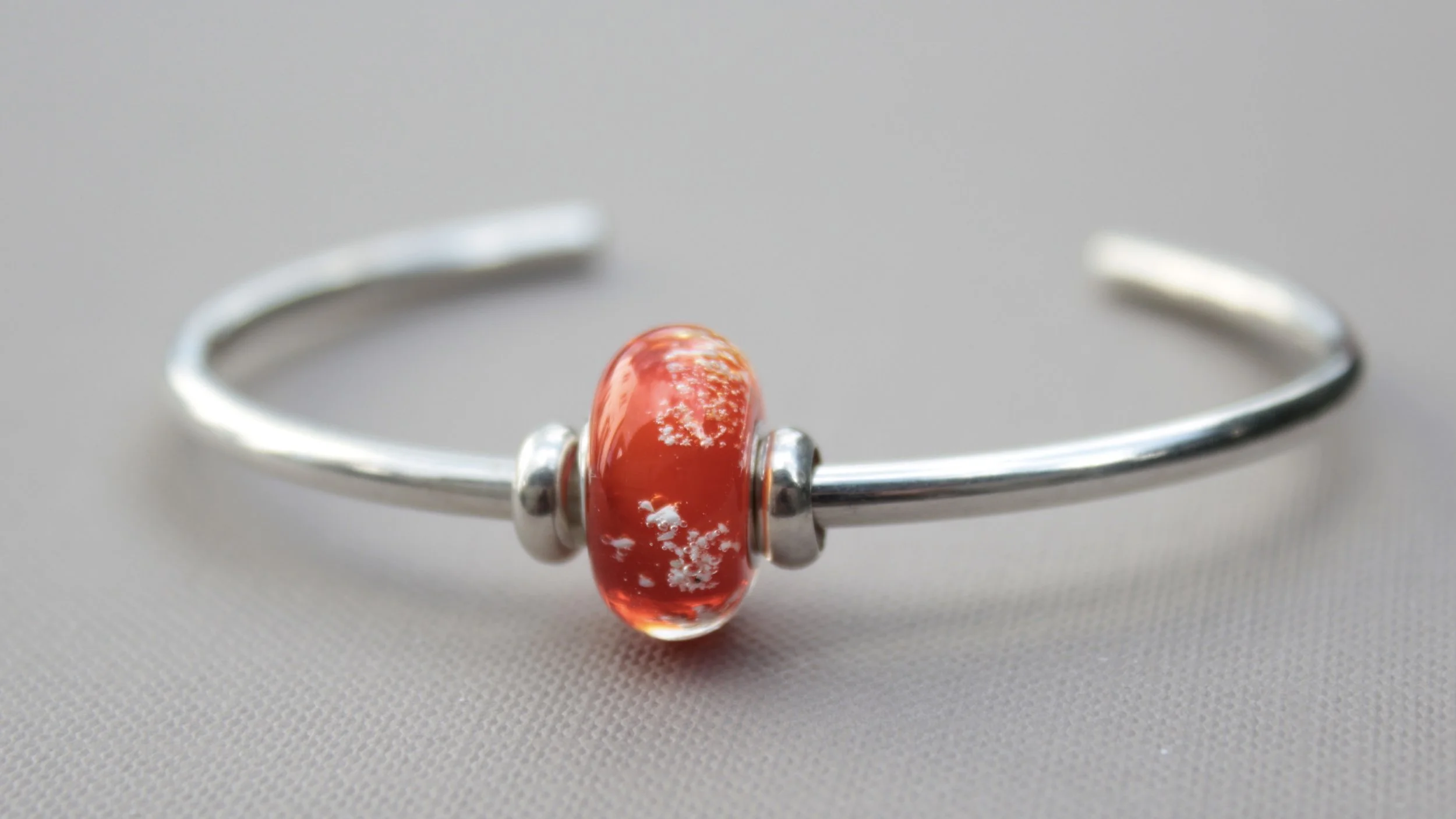 Full view of charm bead on cuff bracelet