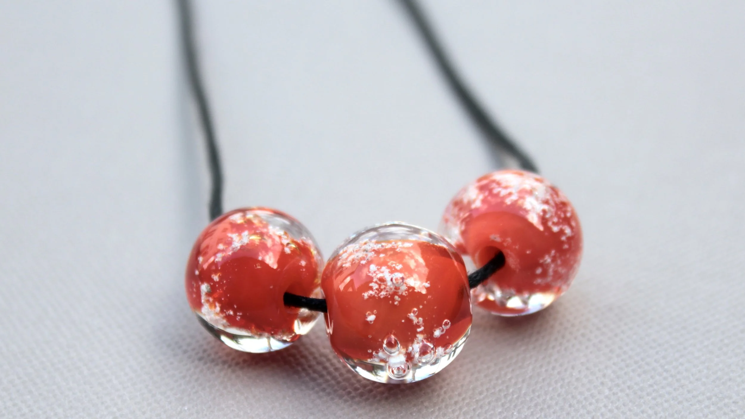 Smaller hole beads strung onto a simple cord
