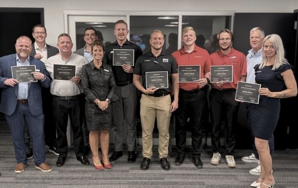 Emerging Leader Development Graduates Posing for Picture. 15 Employees Holding Graduation Certificates.