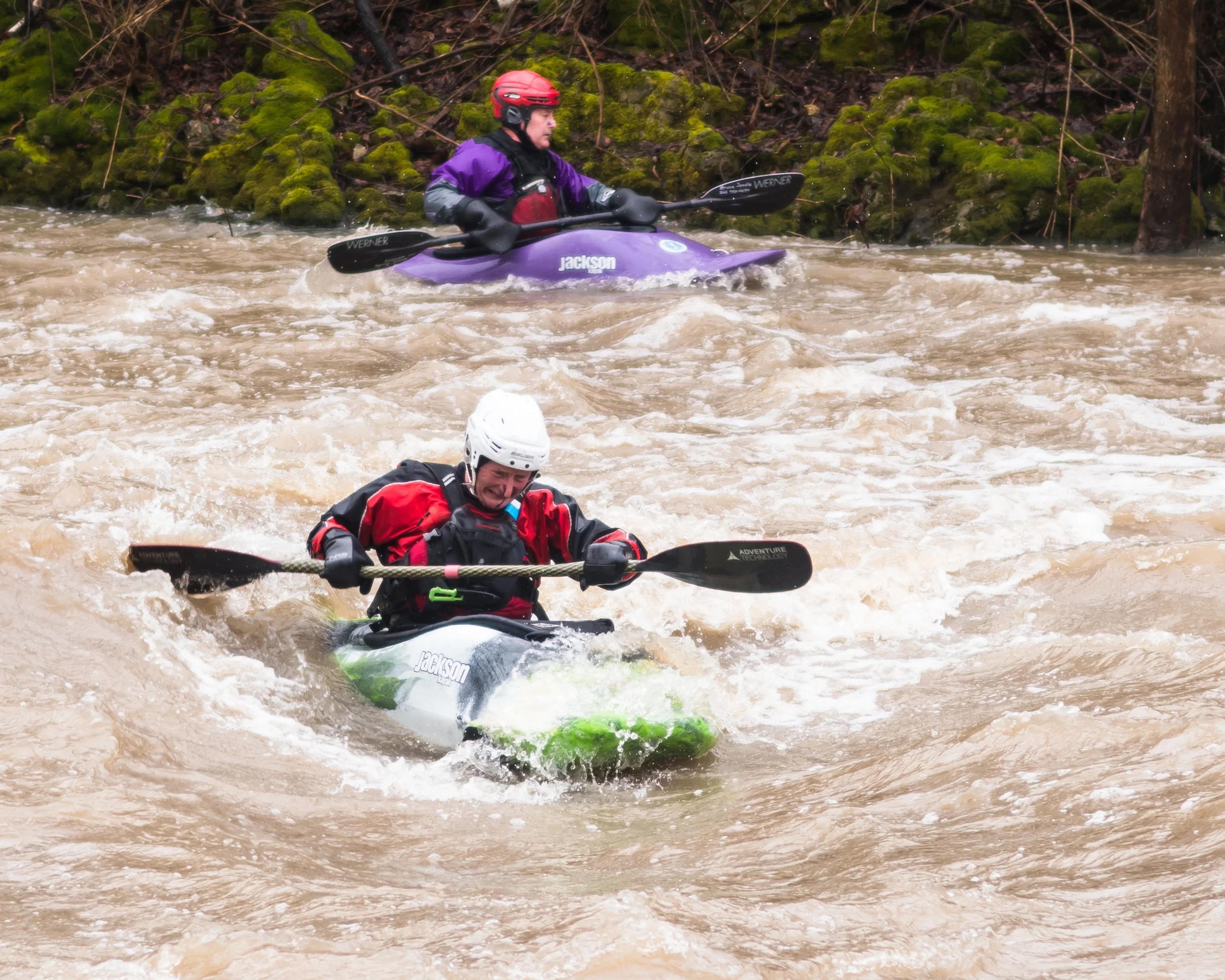 Whitewater kayakers Bruce Jondle and Jozef Milewsski fight through the rapids of the Root River during rainy conditions on Sunday
