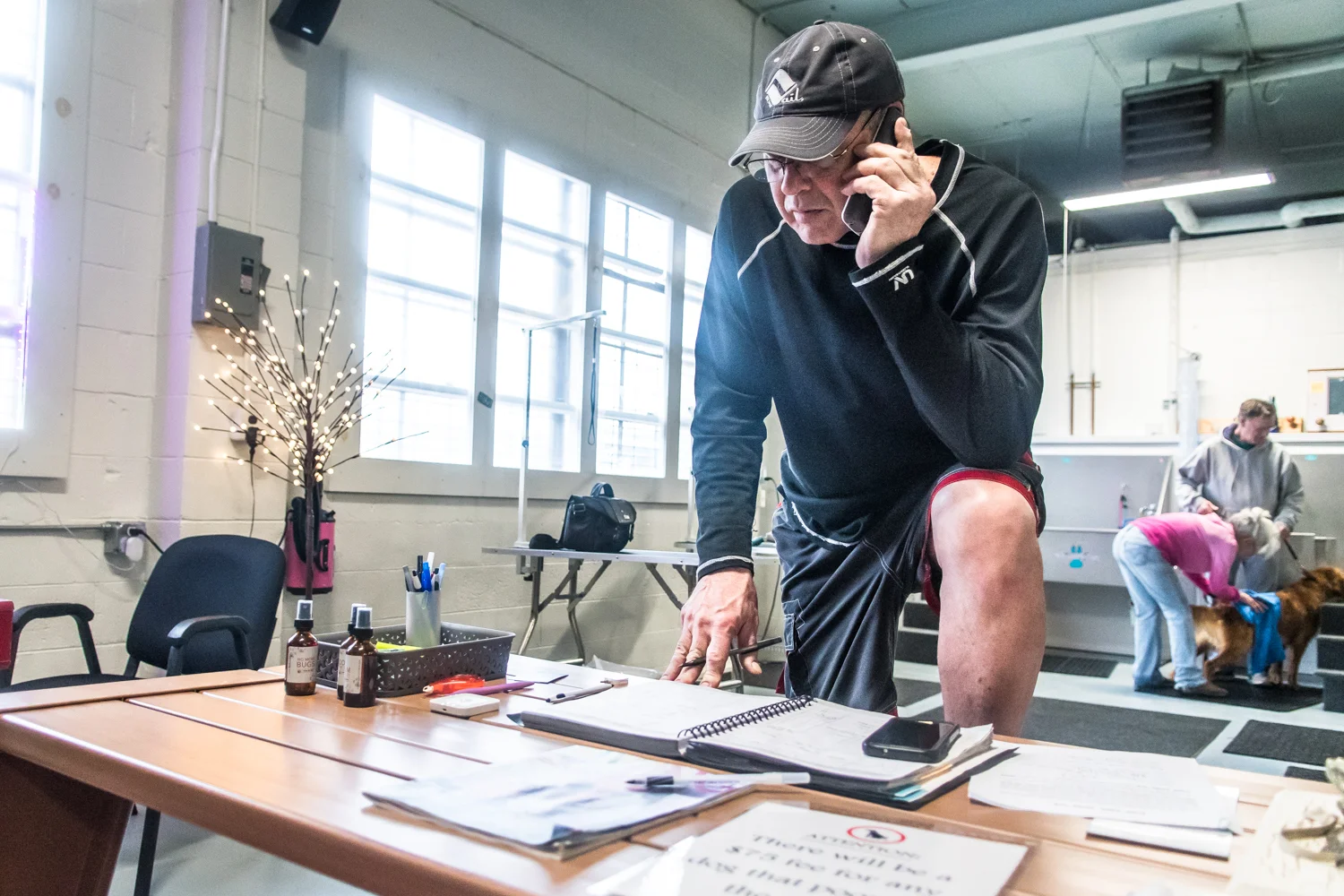 Owner of Club Aqua Paws, Mike Iwon, Racine, takes calls between clients at his business on Lathrop Ave in Downtown Racine.