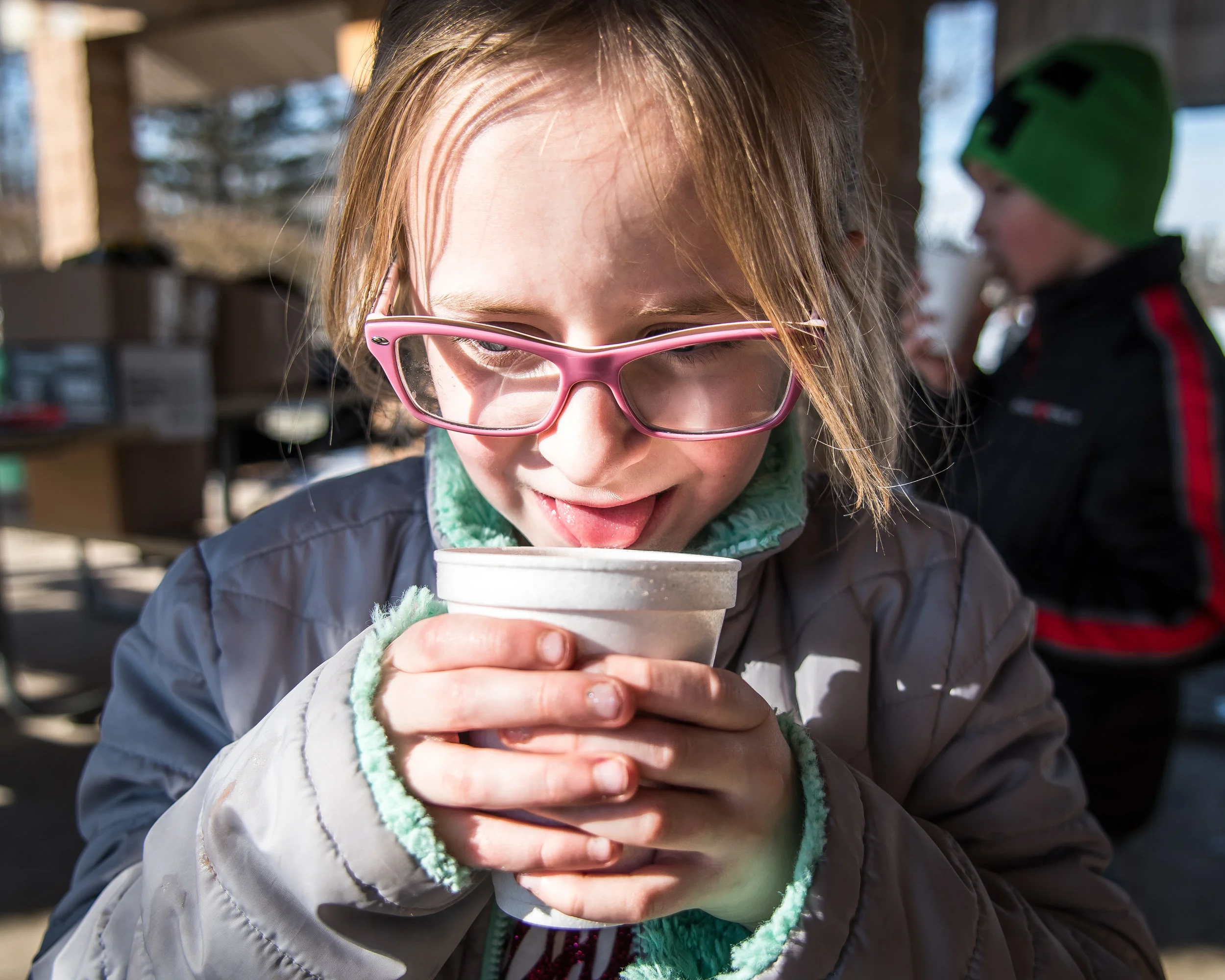 Josie Ehlen, 6, takes her first sip of a piping hot cup of hot chocolate at Burlington’s Hot Chocolatefest Saturday afternoon.