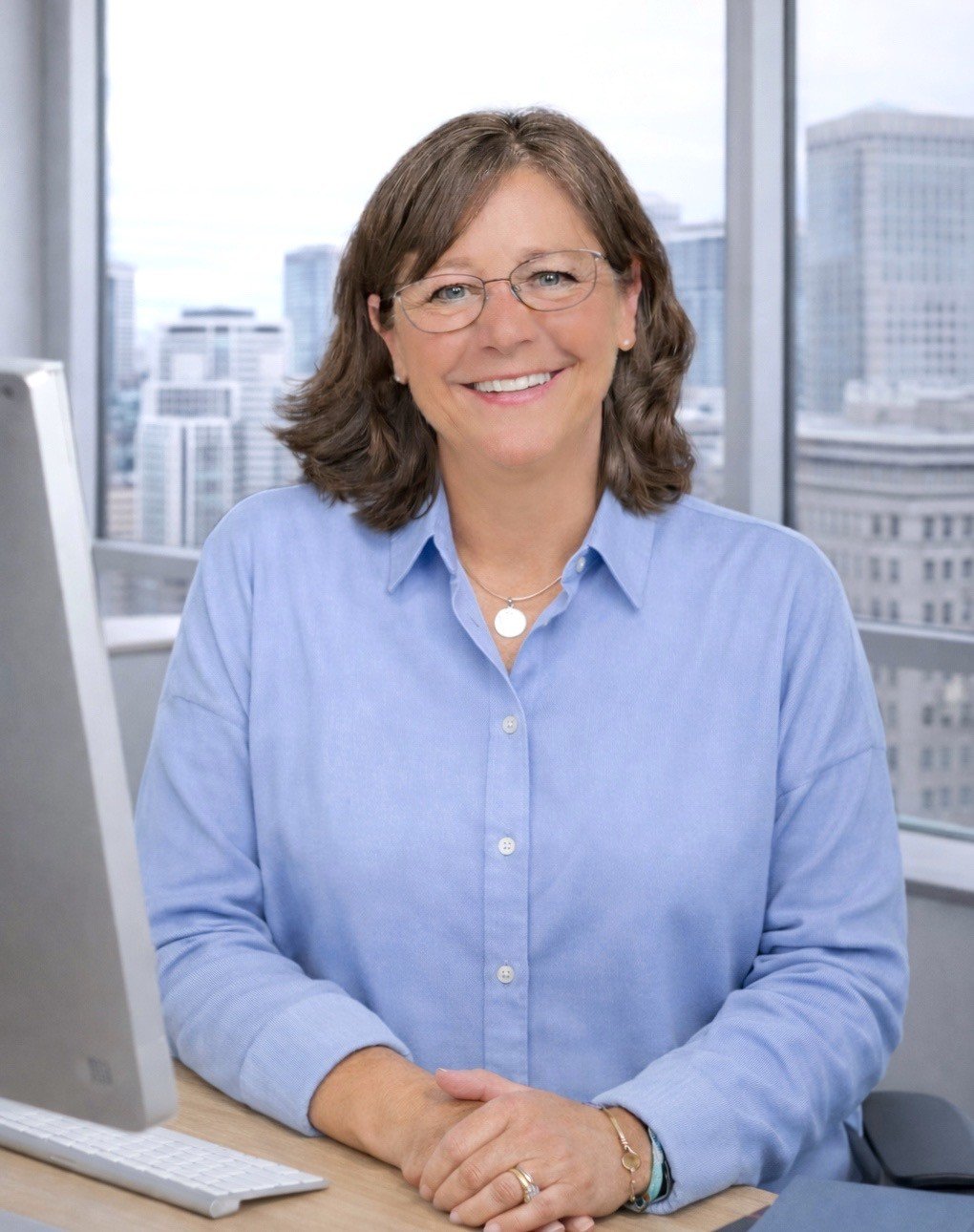 Sara, life coach and educator, smiling in a modern office with city views in the background