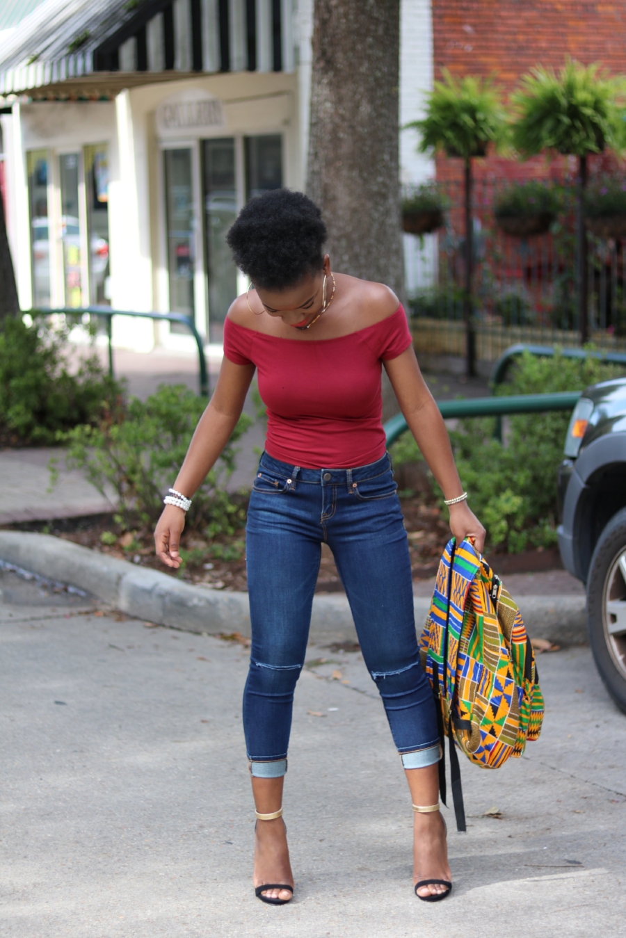 cropped distressed jeans with afro puff