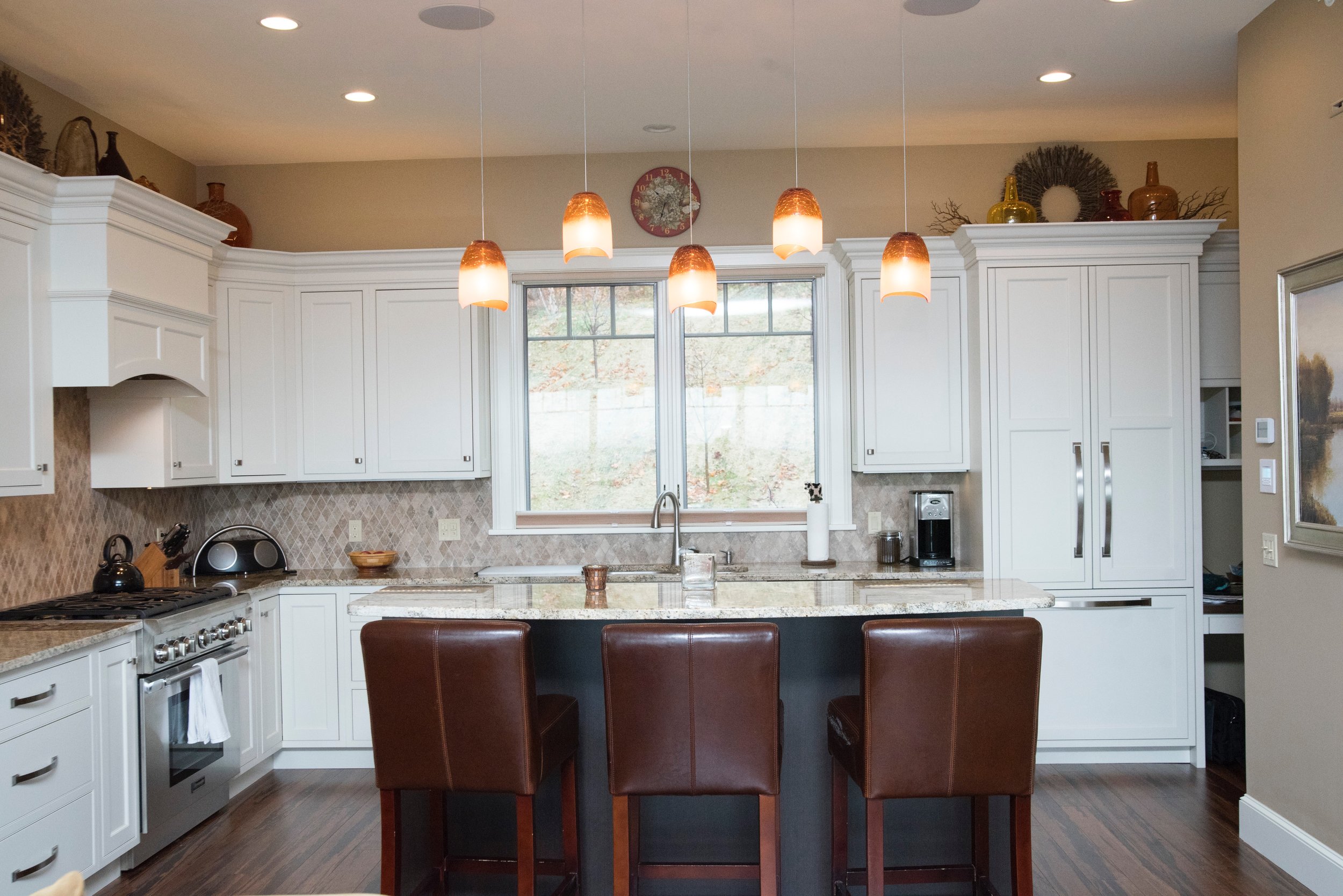 Quechee 2015 The clean lines of this kitchen and unique lighting features highlight balance of colors and warmth.jpg