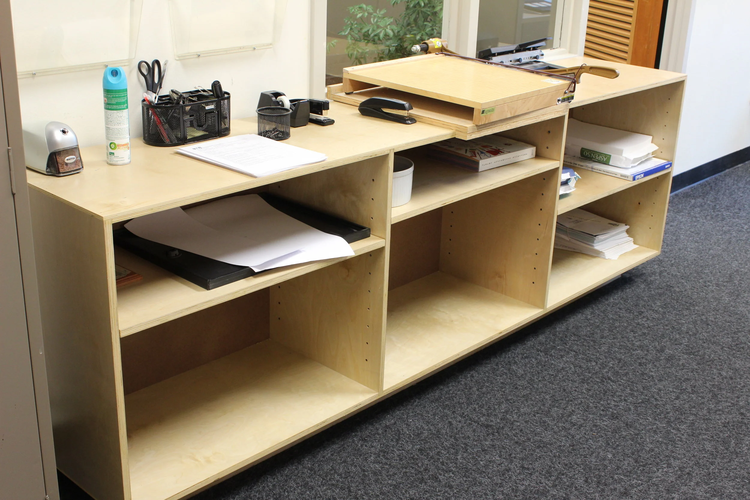  After seeing some of the CNC work I had done around the building I was asked to make a piece for the front office. They were using an old table to hold all of their office supplies and needed some extra storage and shelves. 