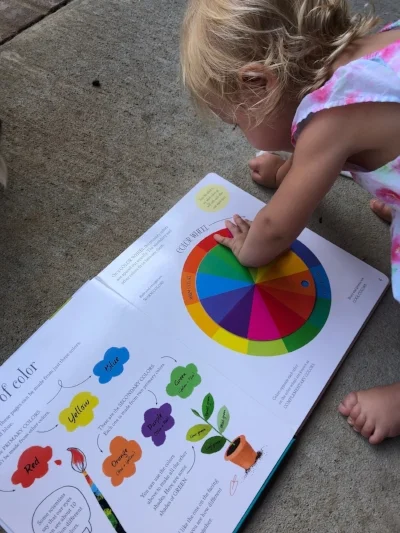 Evie playing with the Big Book of Colors