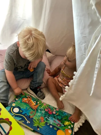 Evie and her friend Harrison reading Jungle Sounds