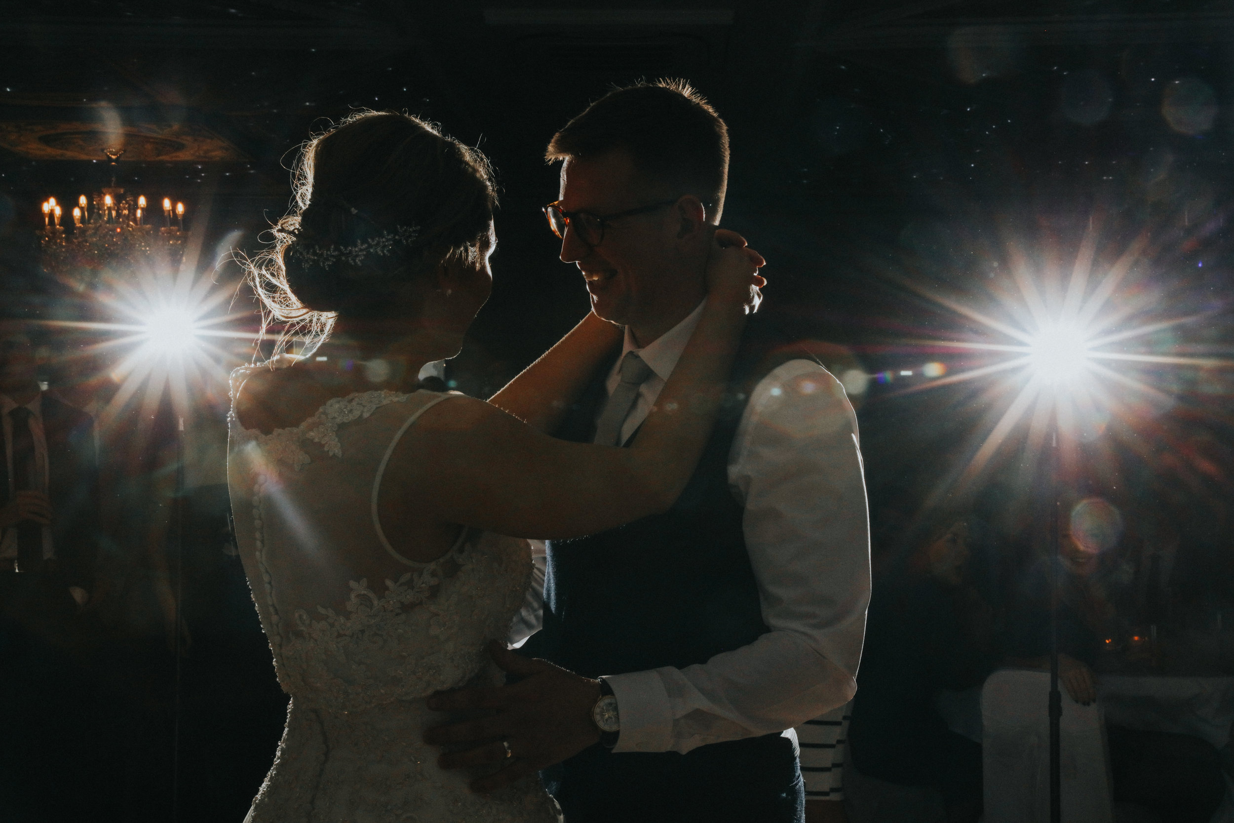 bride and groom cuddling while taking first dance