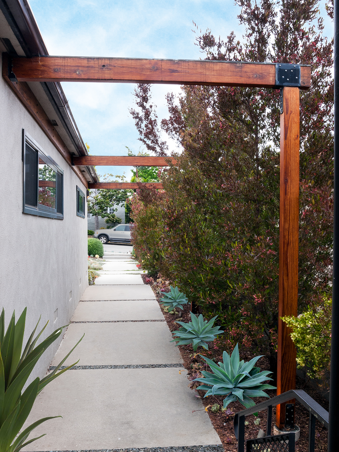Bold yet simple architectural details: "spider legs" inspired by iconic mid-century architect, Richard Neutra, added drama and anchored the design of the new front entry.