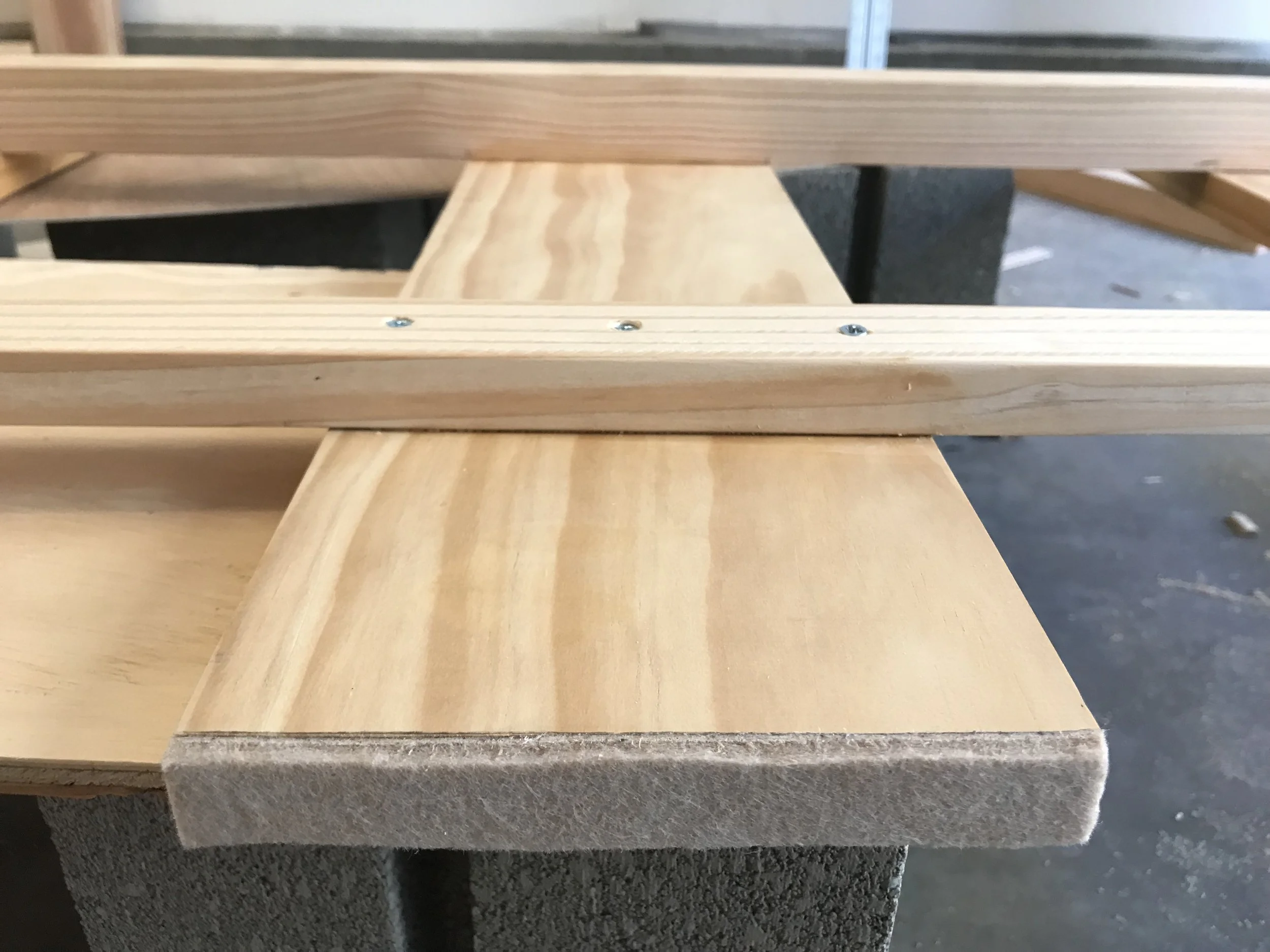 Furniture pads to protect the lino under the support rail