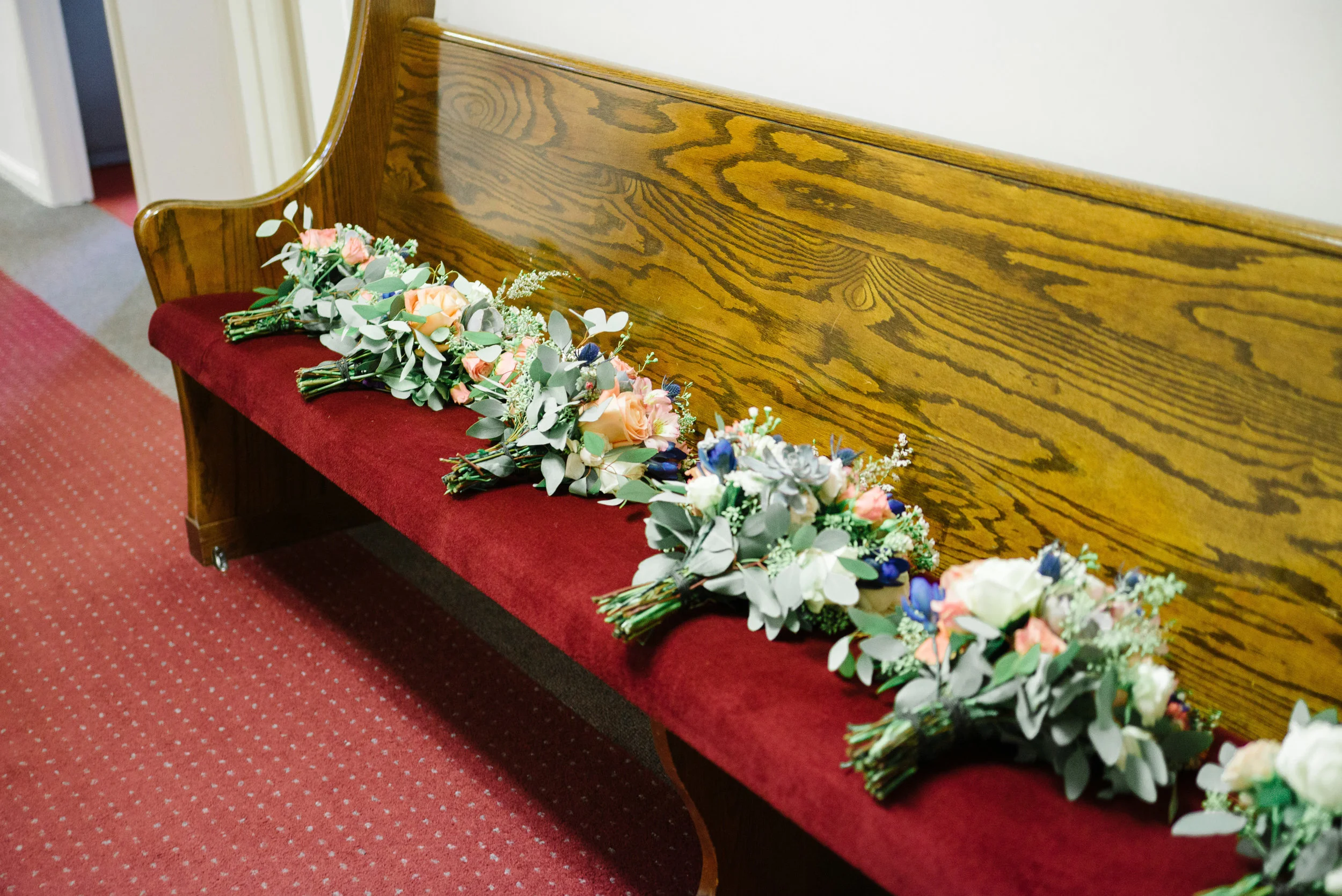 The succulents are stuck onto wire "stems" and then placed into the bouquets.